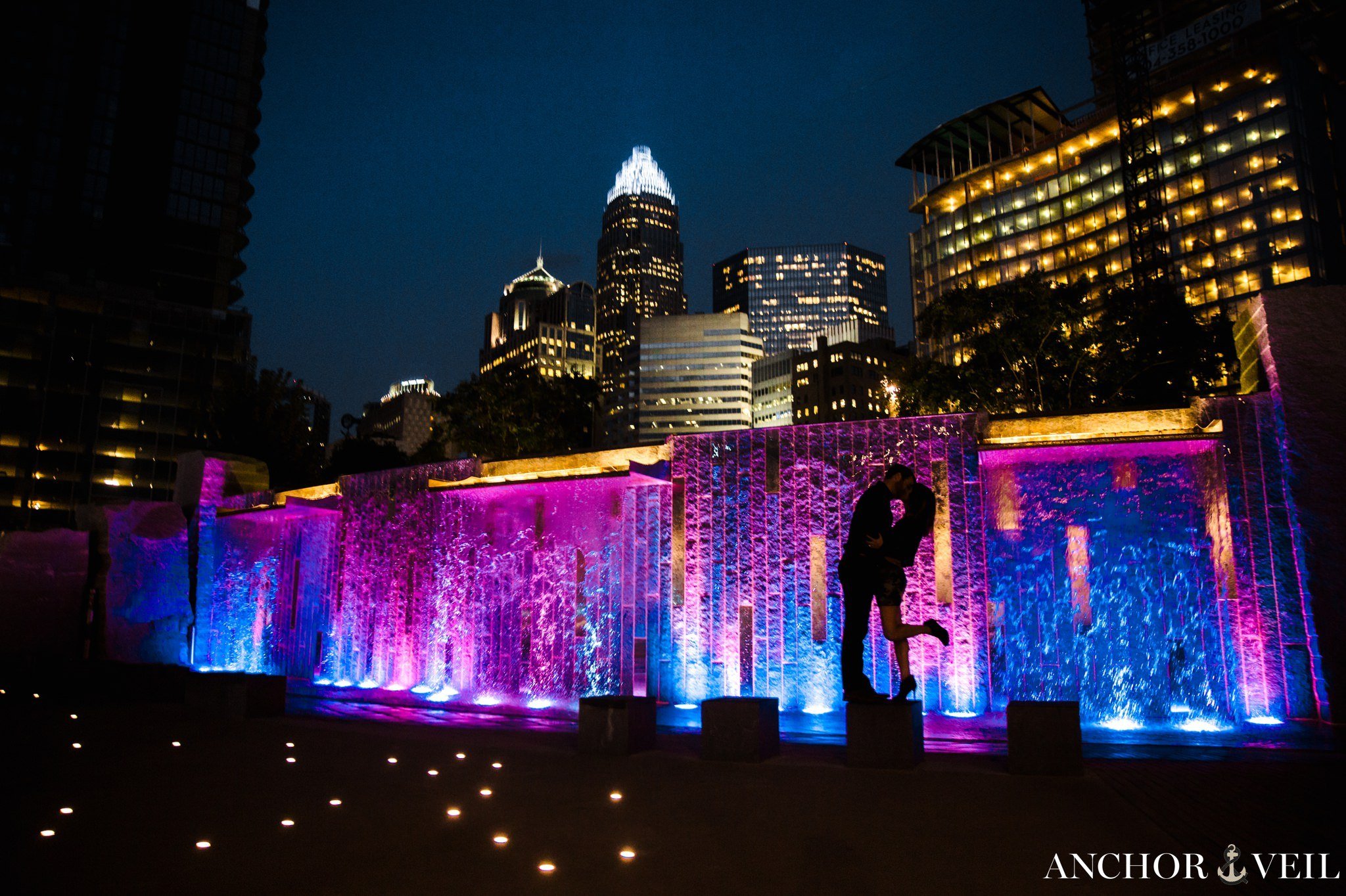 tomare bearden park lights with the Charlotte Skyline during the Uptown Charlotte Engagement Session