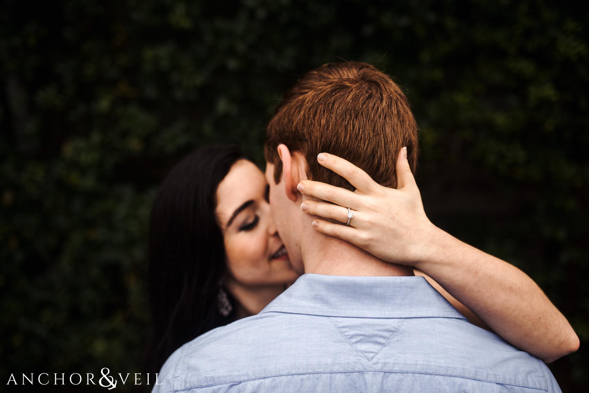 dew in the ahir and her ring during their folly beach and legare waring house engagement session