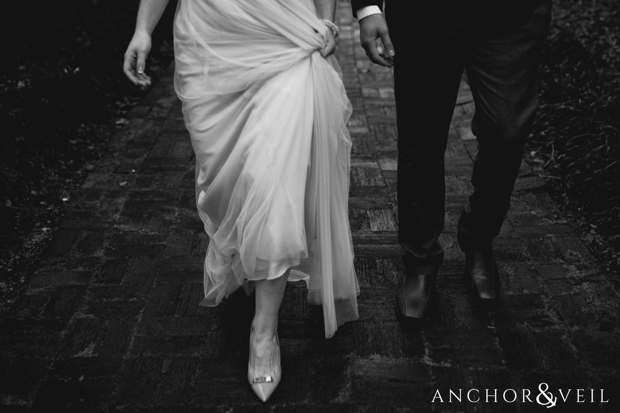 walking in the dress during their legare waring house engagement session
