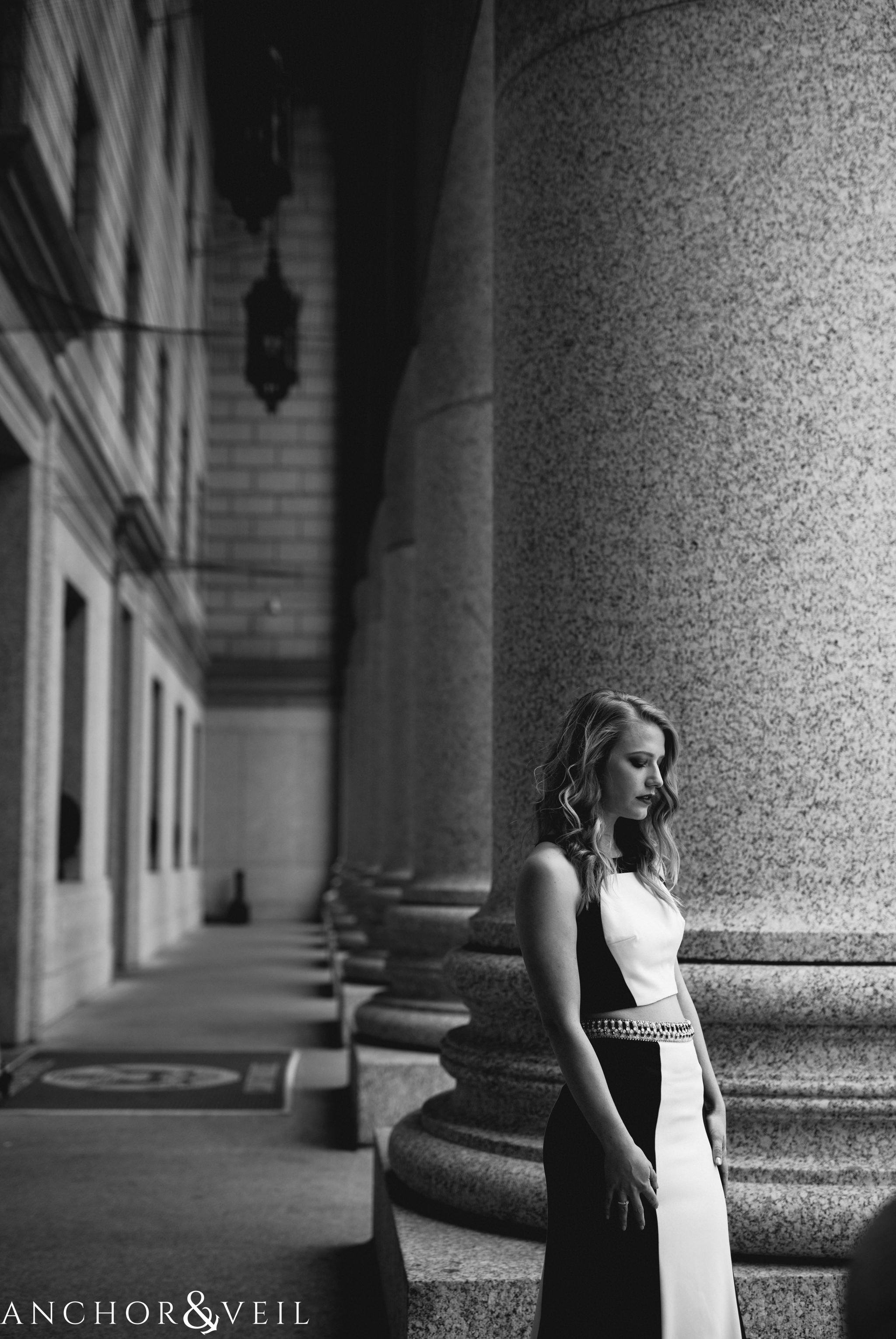 in front of pillars in black and white during their bethesda terrace central park anniversary session