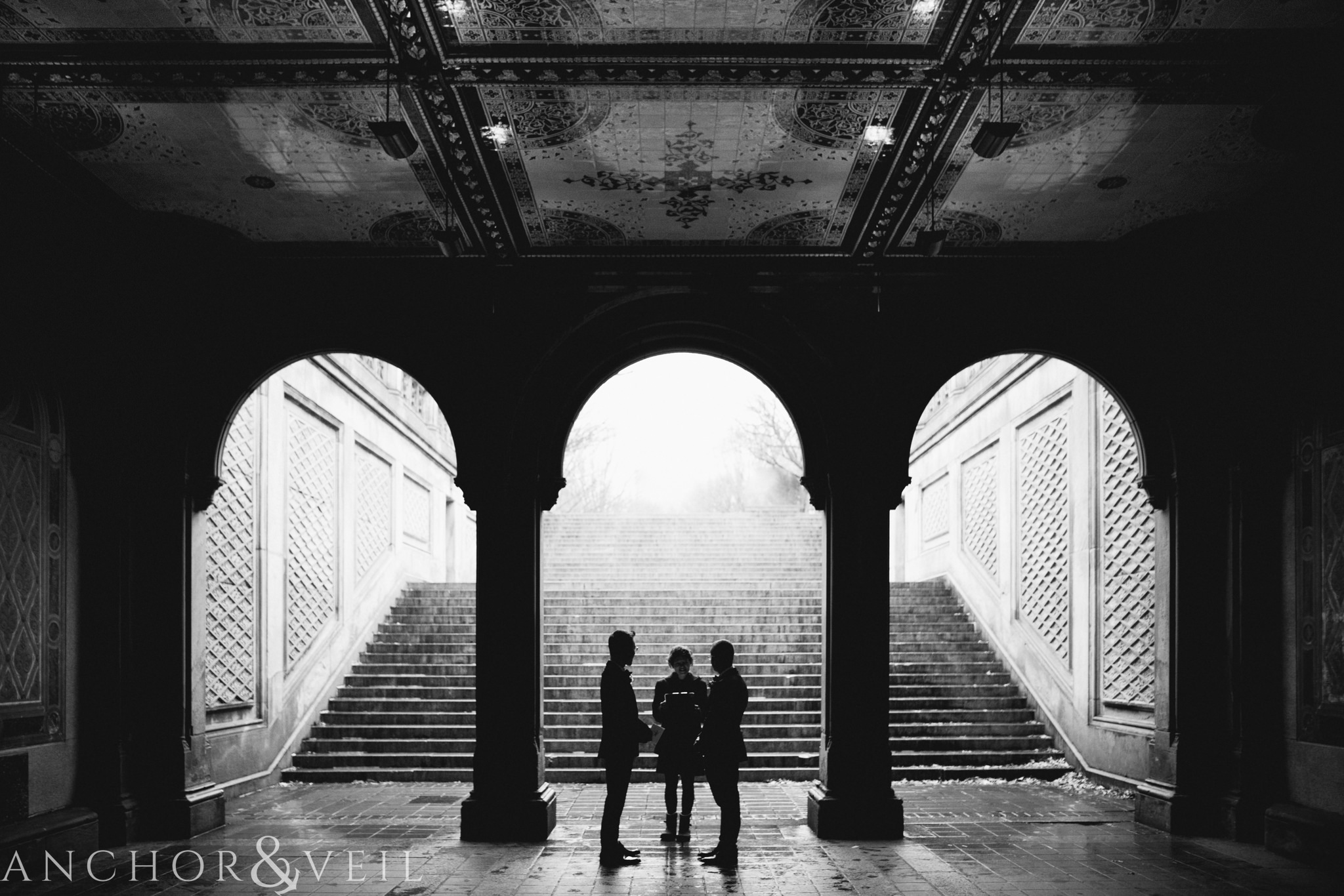 standing under the tunnel during their central park elopement in bethesda Terrace