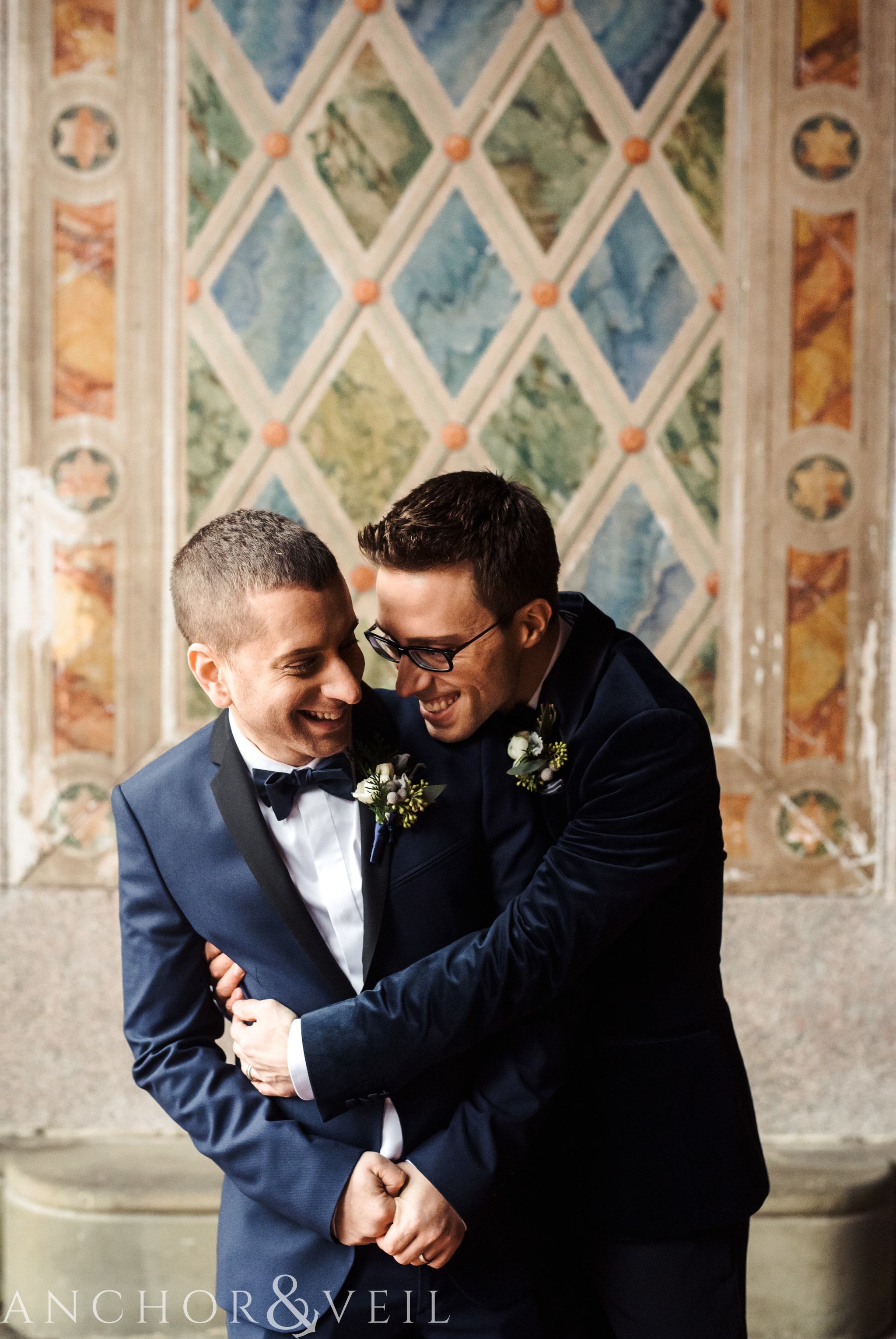 hugging each other during their central park elopement in bethesda Terrace