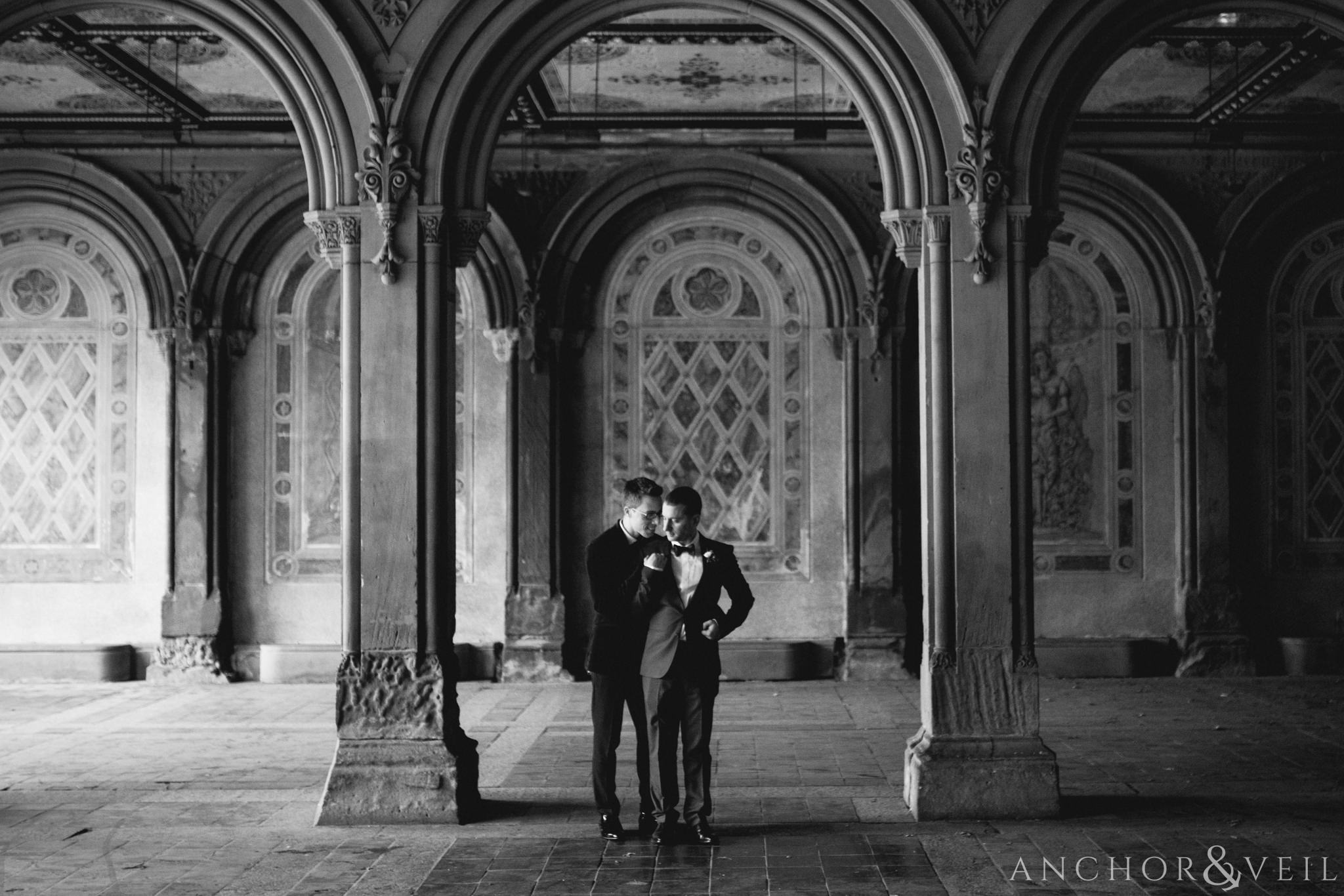 black and white under the arches during their central park elopement in bethesda Terrace