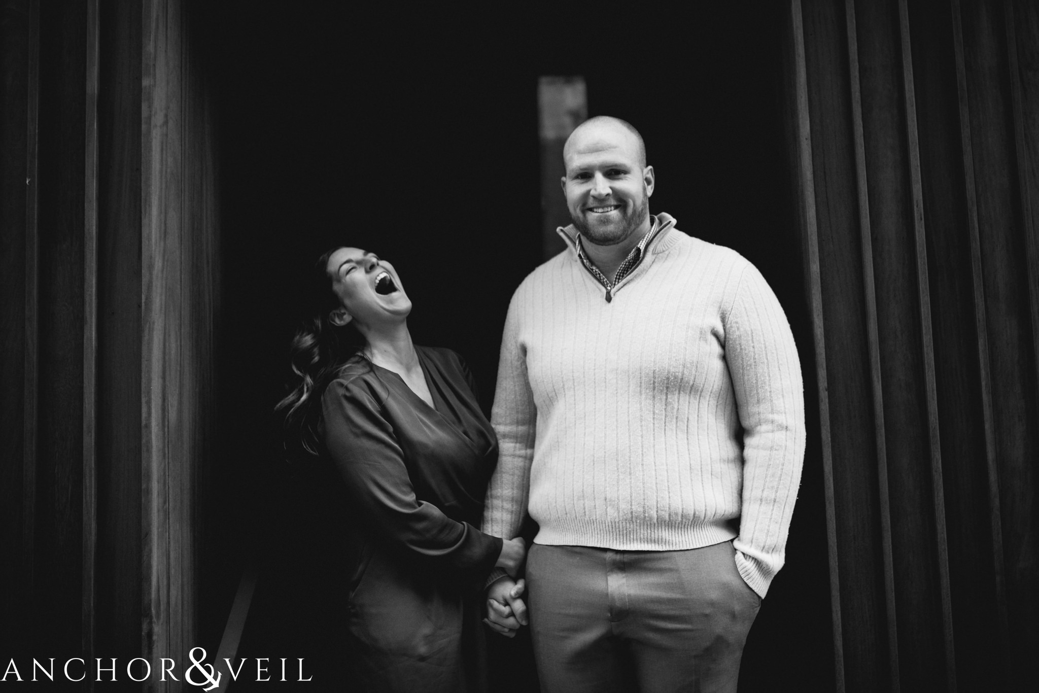 laughing in between the walls During their Dumbo Brooklyn New York engagement session