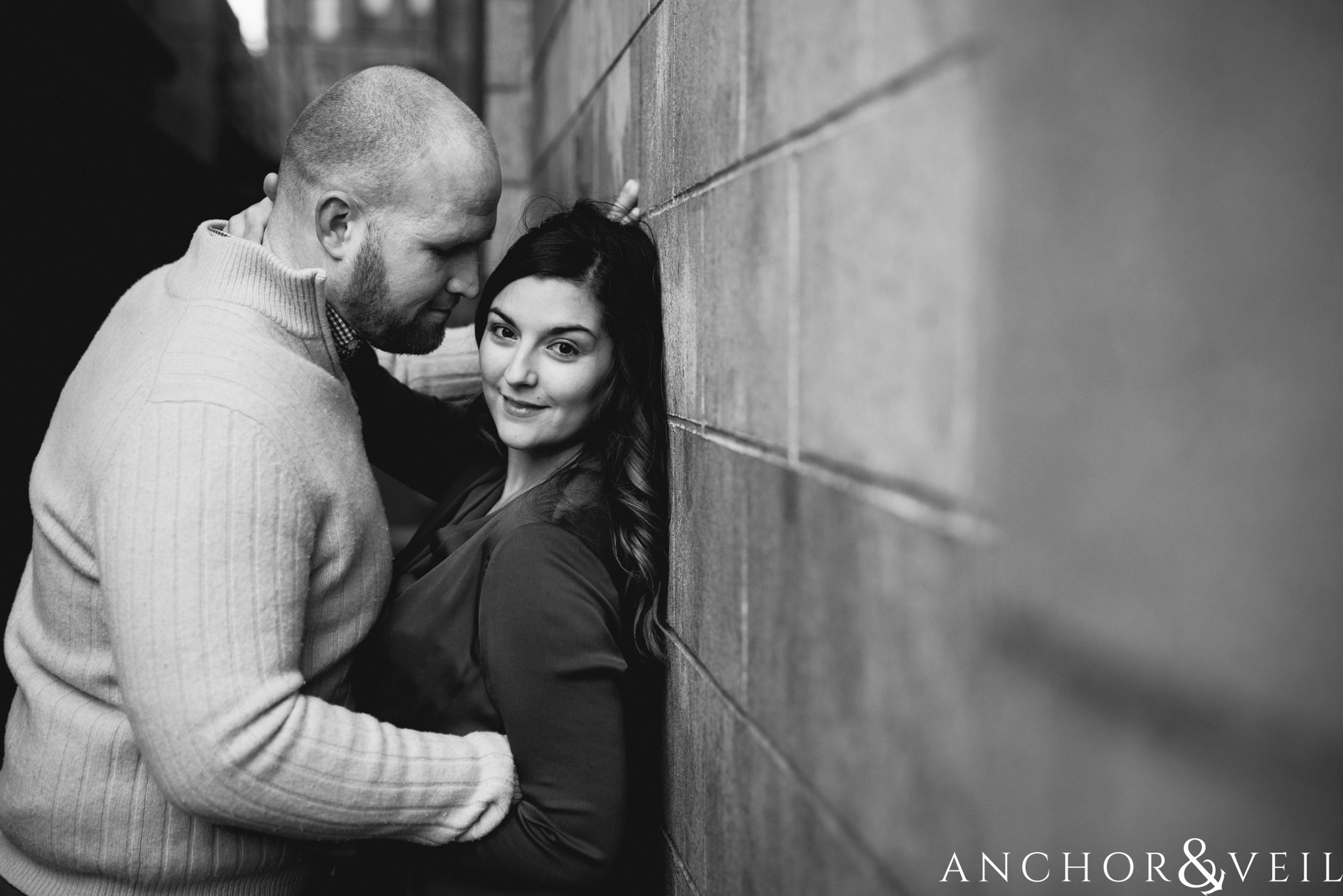 leaning against the wall During their Dumbo Brooklyn New York engagement session