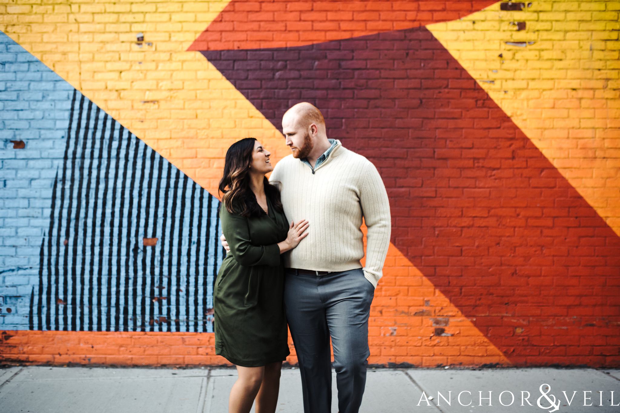 in front of the art During their Dumbo Brooklyn New York engagement session