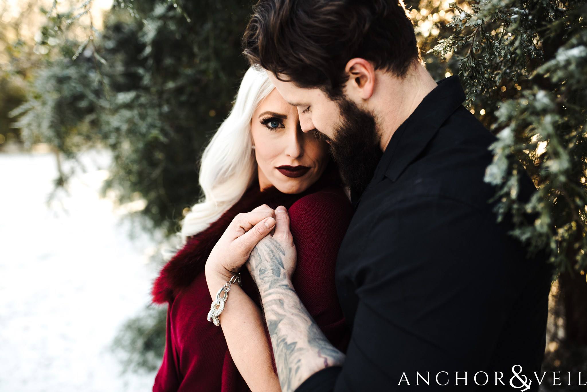 in close looking at the camera during their charlotte snow engagement session