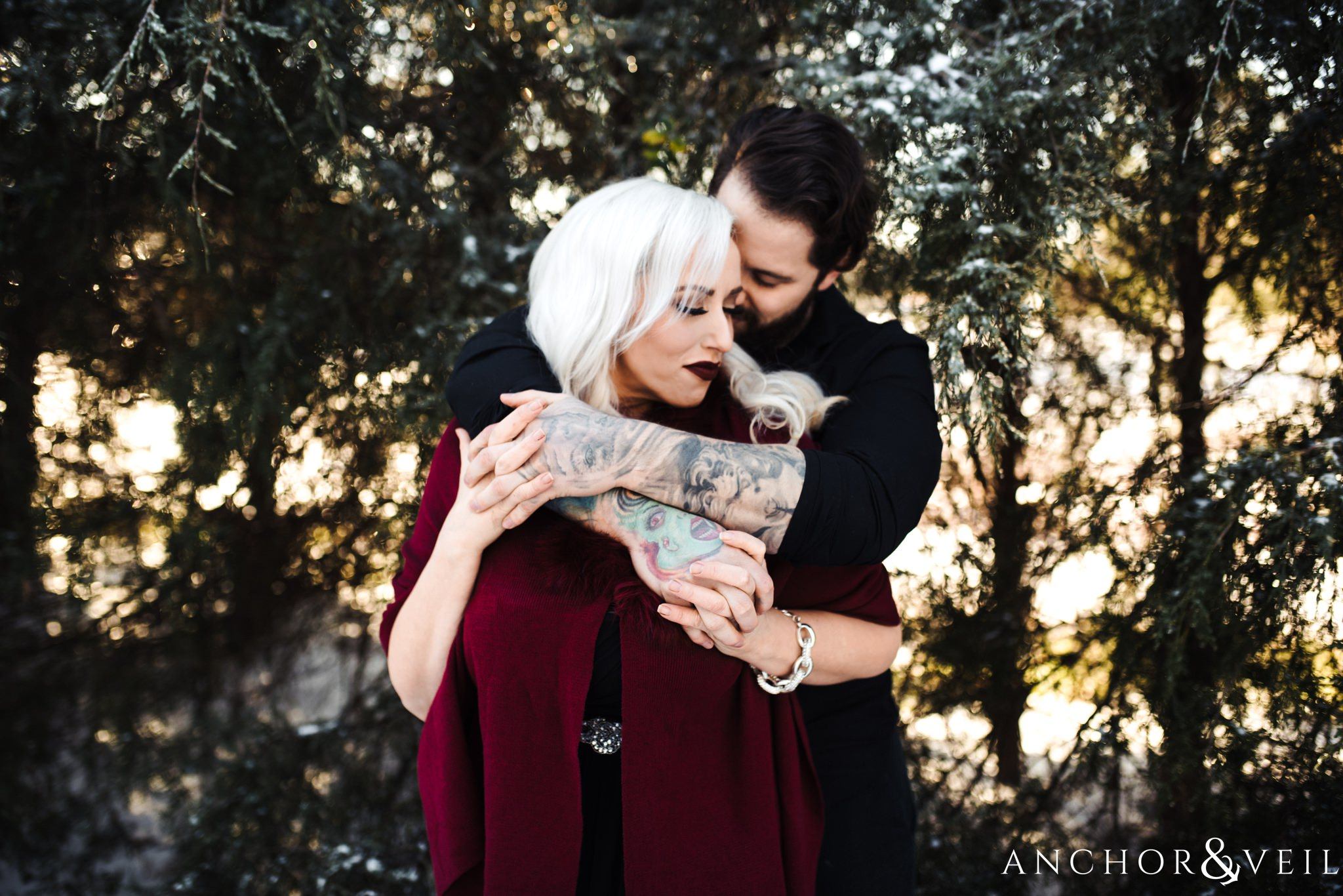 holding hands and holding her tight during their charlotte snow engagement session