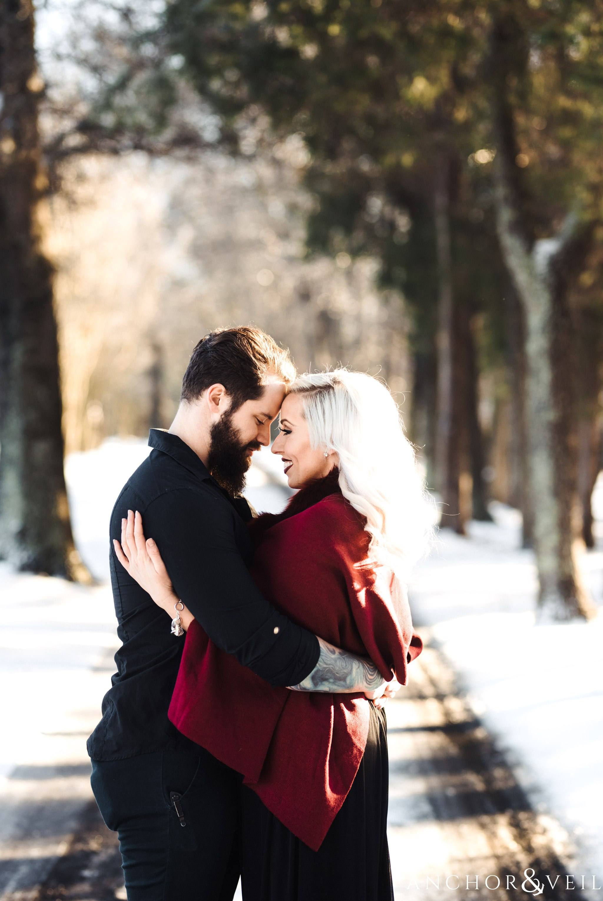 foreheards together holding tight during their charlotte snow engagement session