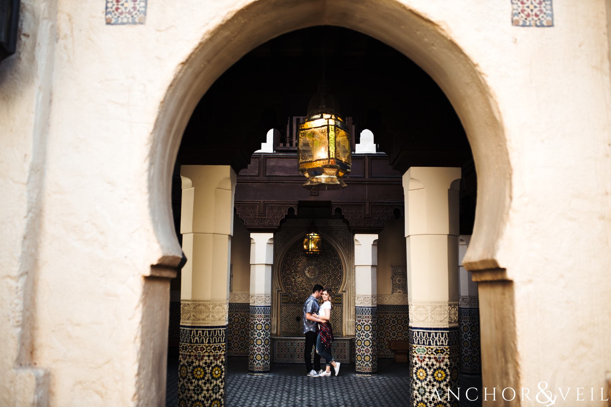 more arches and kissing in morocco during their Disney world engagement session at Disney's Epcot