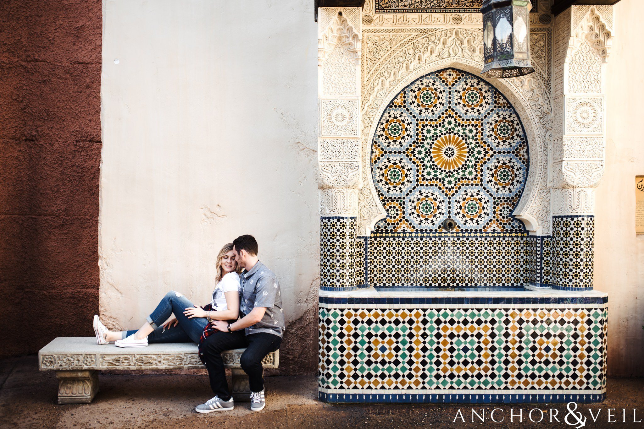 next to the fountain in morocco during their Disney world engagement session at Disney's Epcot