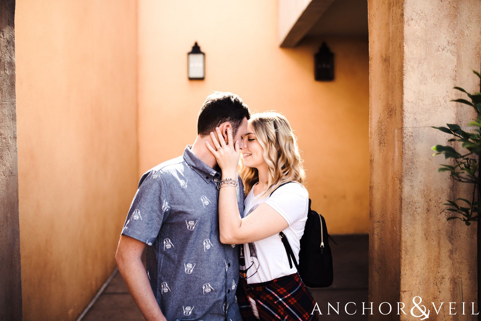 kissing in the orange arches in italy during their Disney world engagement session at Disney's Epcot