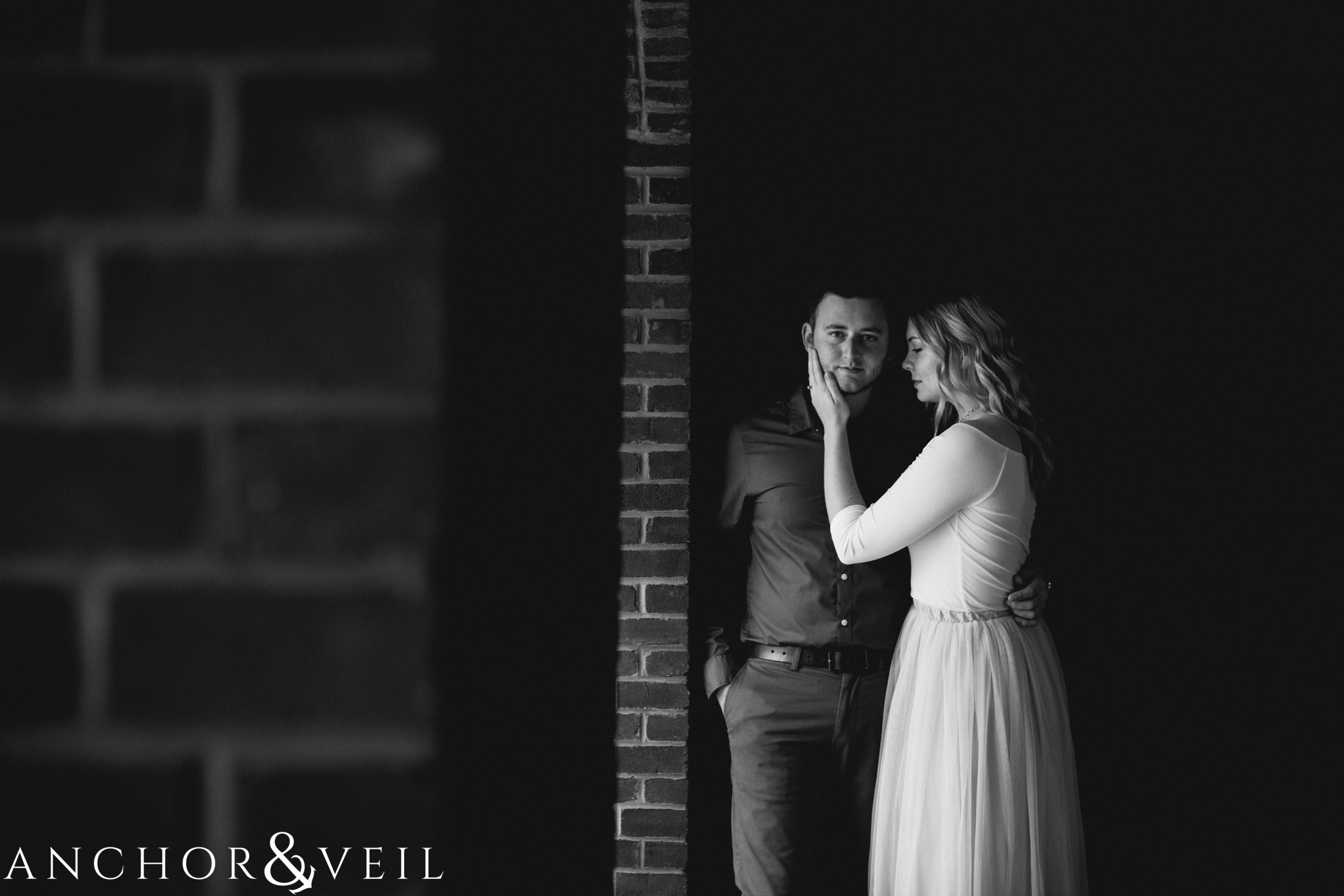 in the shadows during their Disney world engagement session at the Boardwalk Hotel Inn