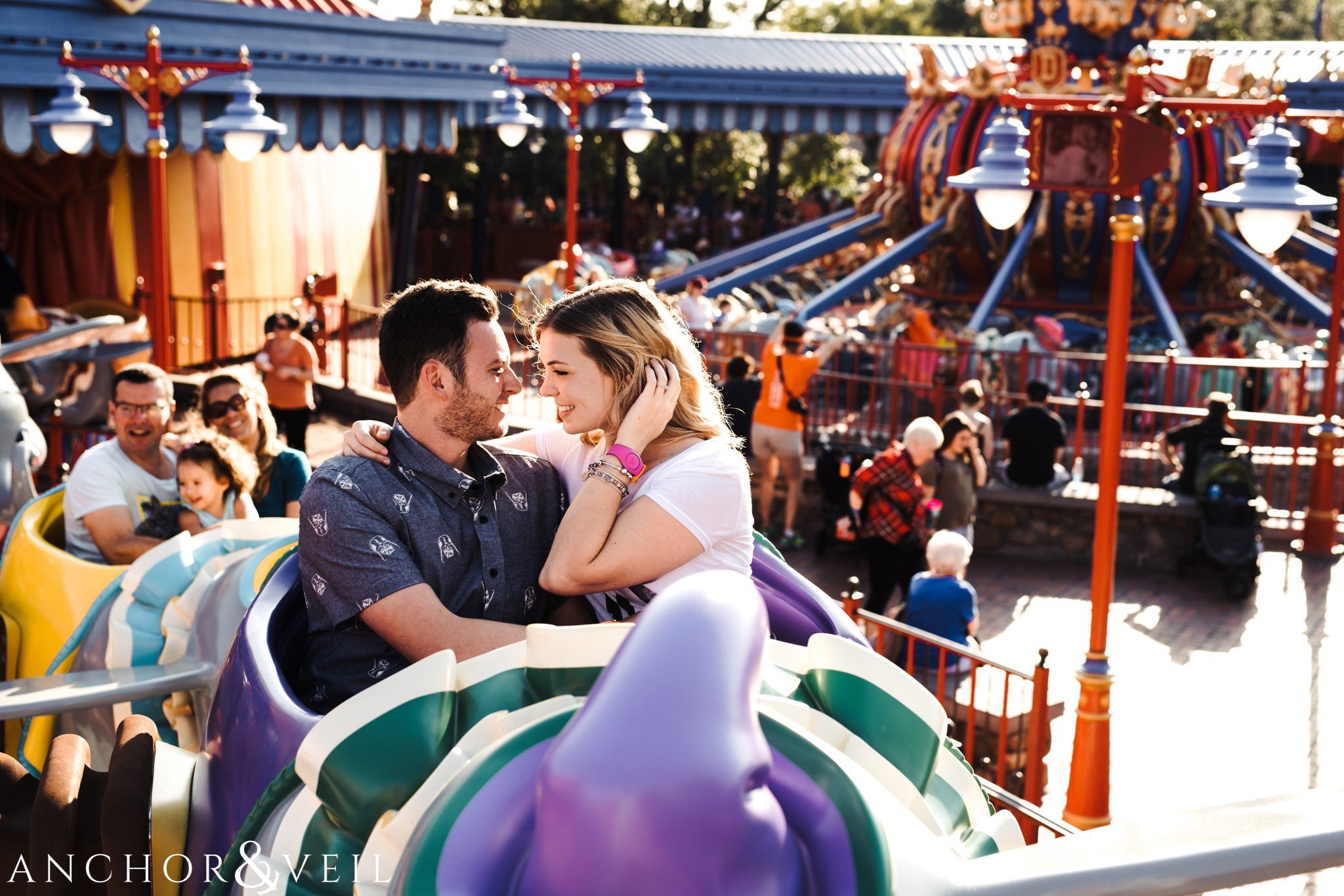 on the dumb ride during their Disney world engagement session at Disney's Magic Kingdom