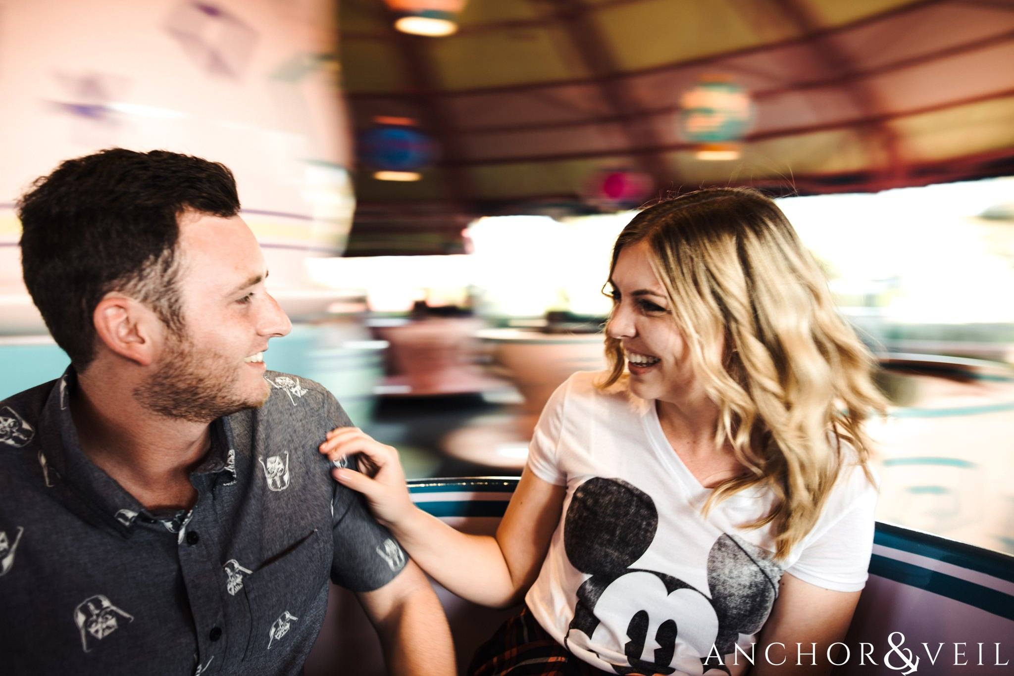 laughing in the tea cups during their Disney world engagement session at Disney's Magic Kingdom