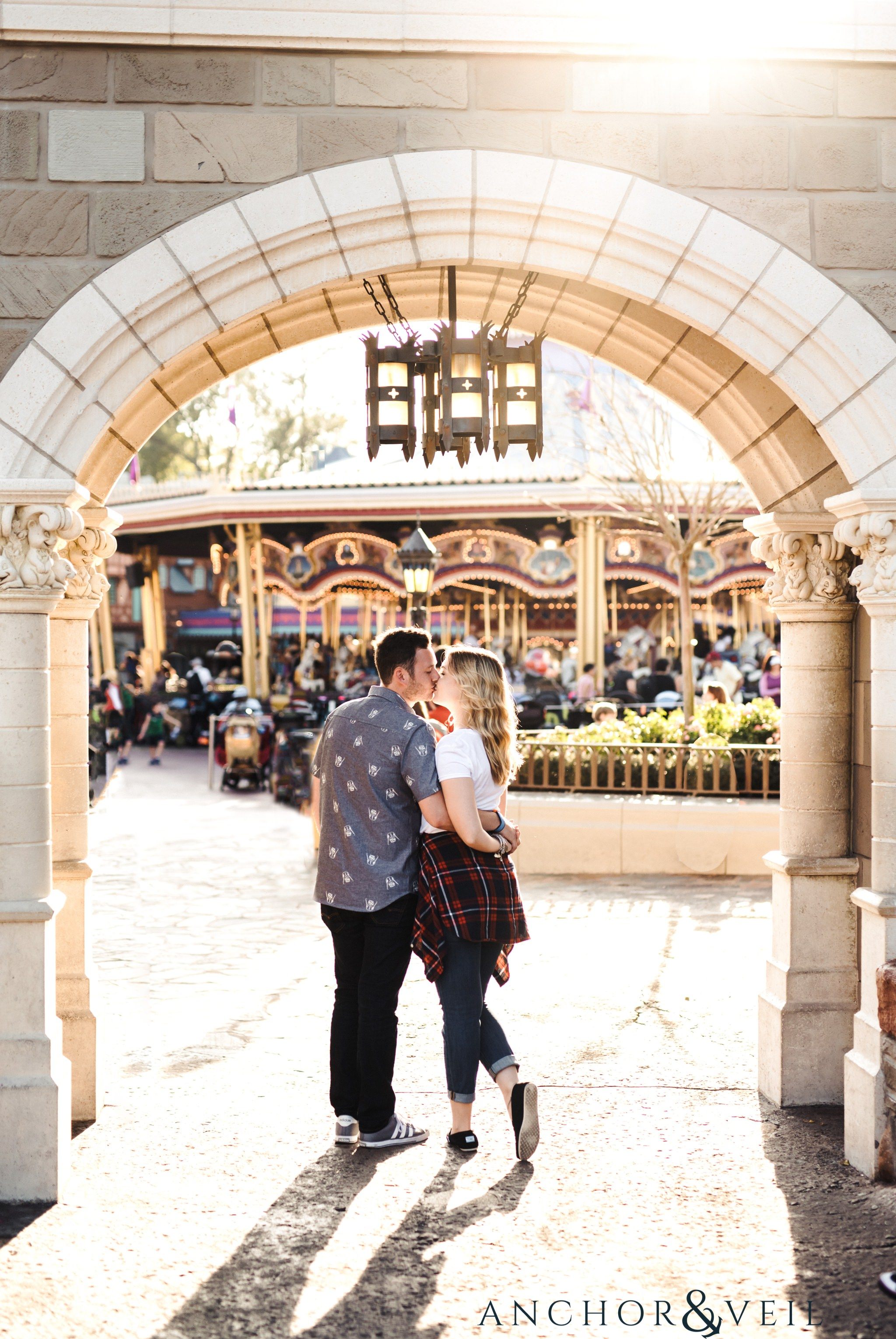 almost kissing under the arches during their Disney world engagement session at Disney's Magic Kingdom