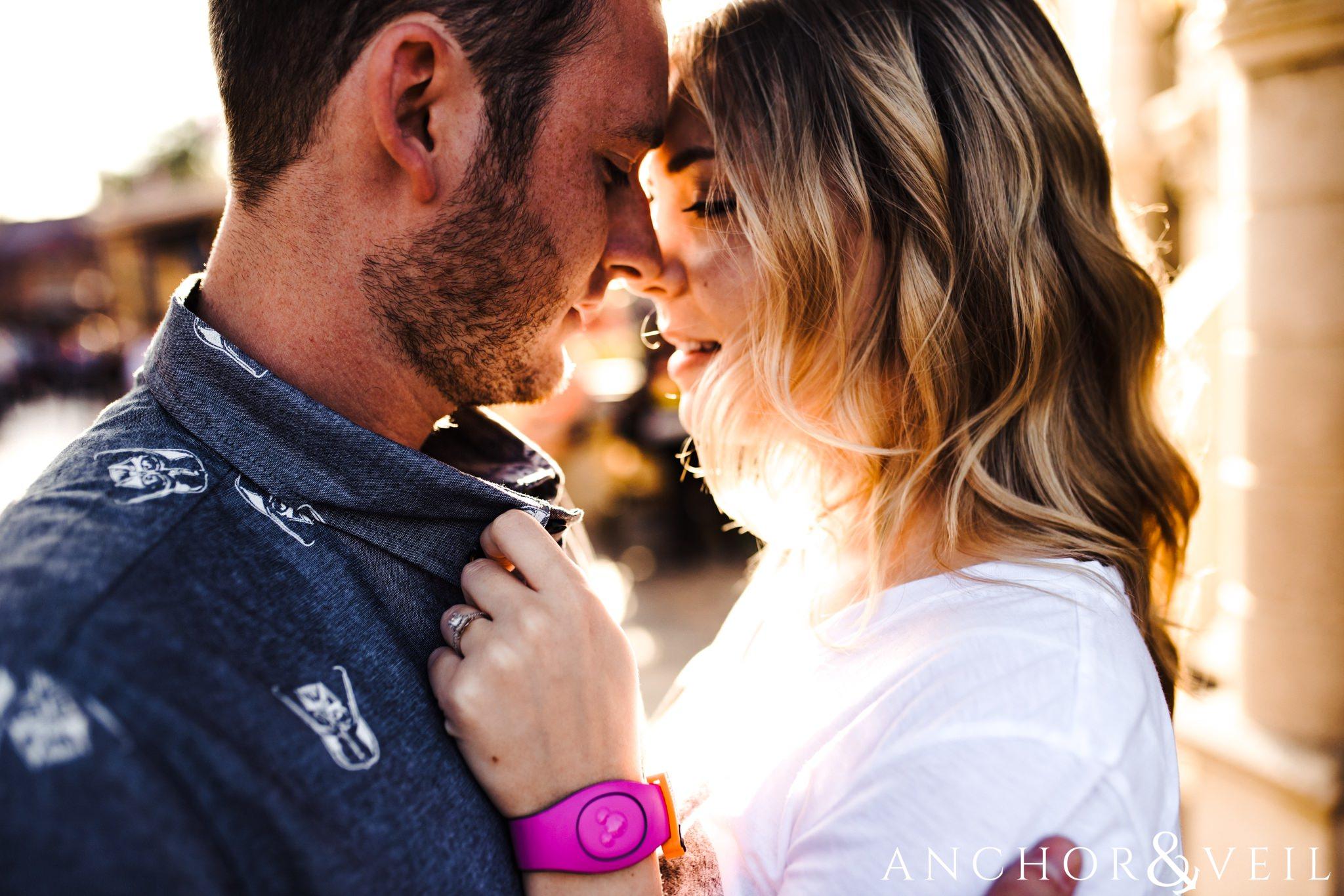 getting really close in love during their Disney world engagement session at Disney's Magic Kingdom