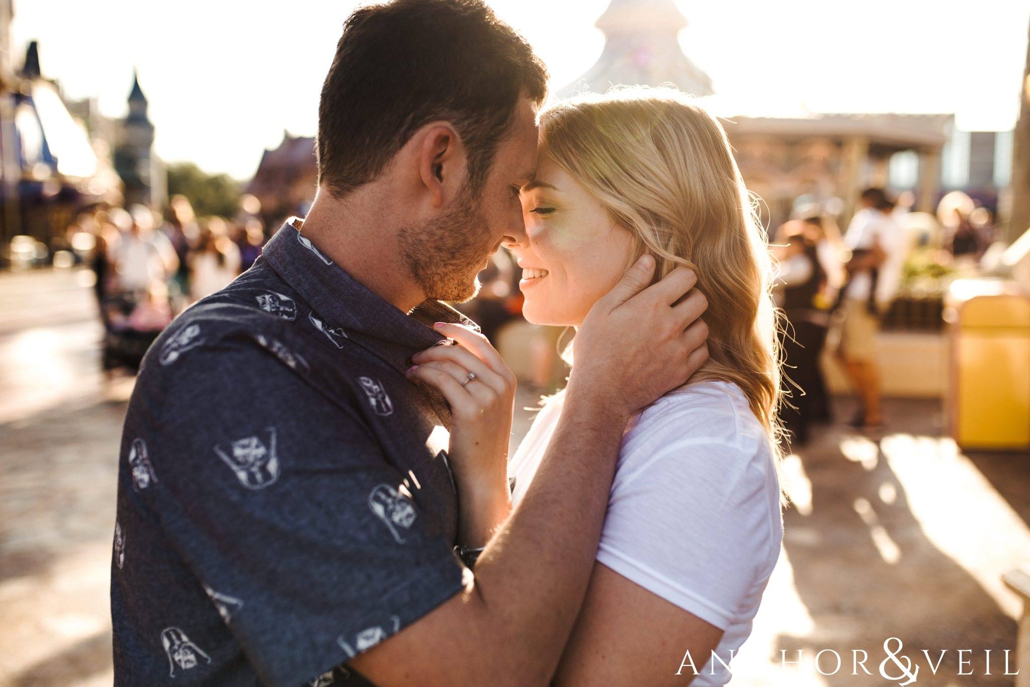 almost kissing during their Disney world engagement session at Disney's Magic Kingdom