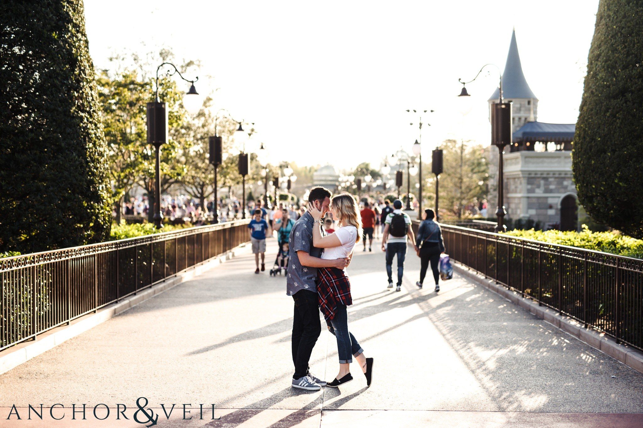 foreheads together on the bridge during their Disney world engagement session at Disney's Magic Kingdom