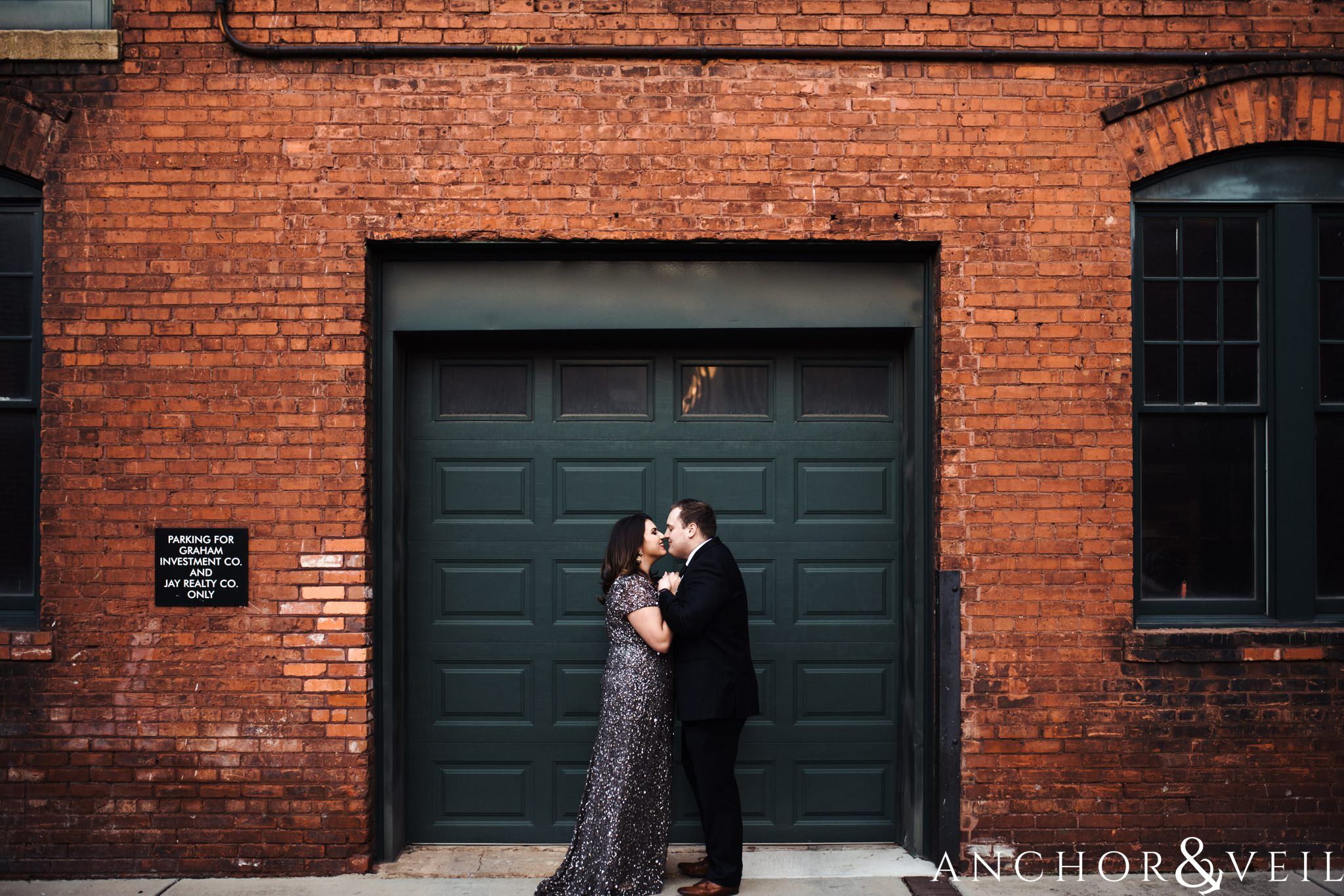 in front of the garage during their southend charlotte engagement session