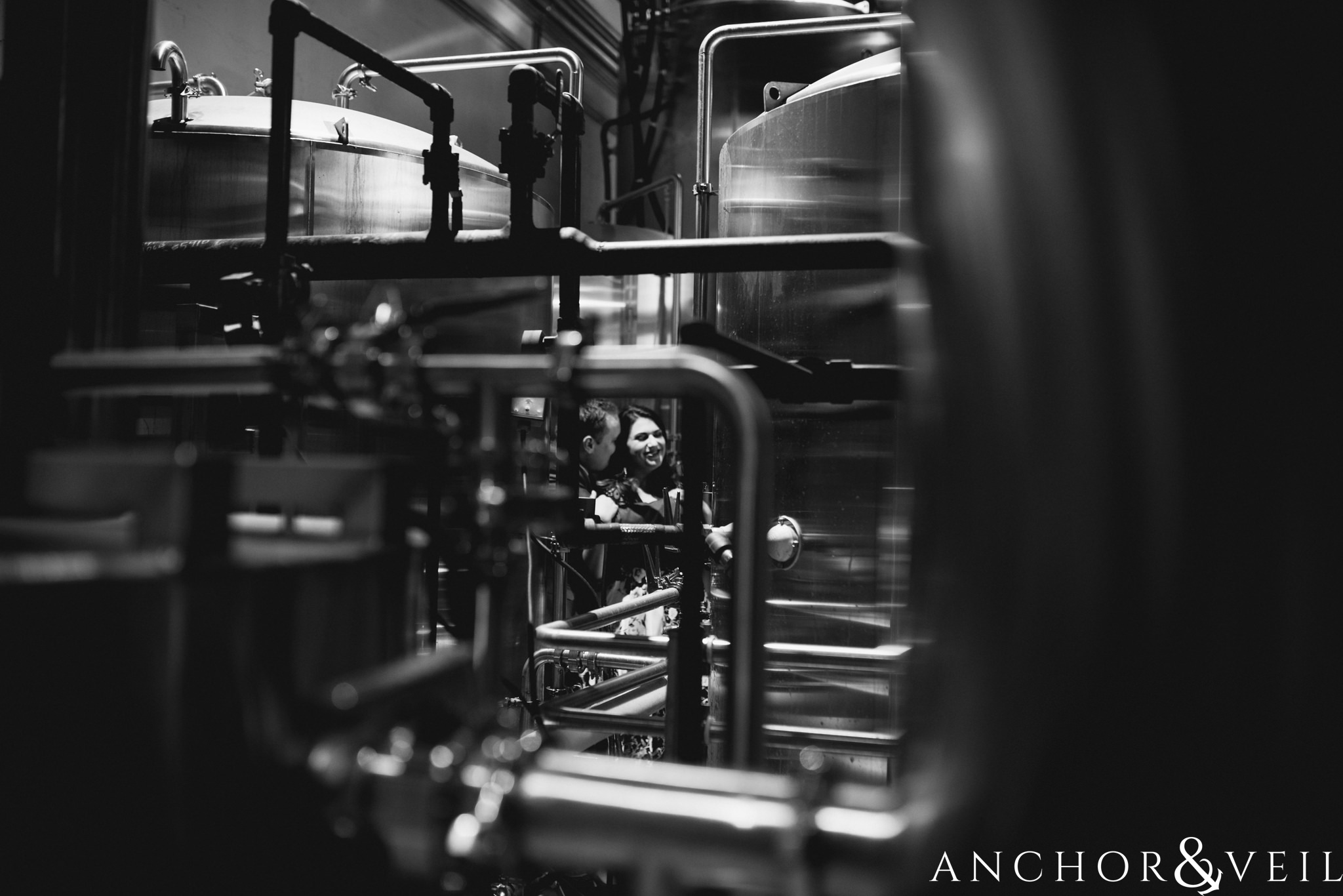 near the brewing tanks during their southend charlotte engagement session