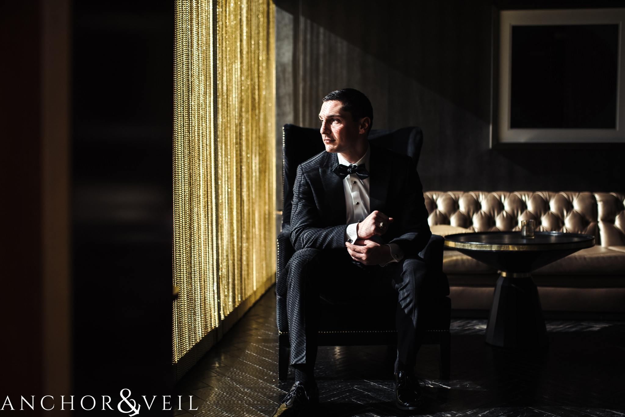 groom getting ready in the punch room during their ritz Carlton wedding in Uptown Charlotte NC