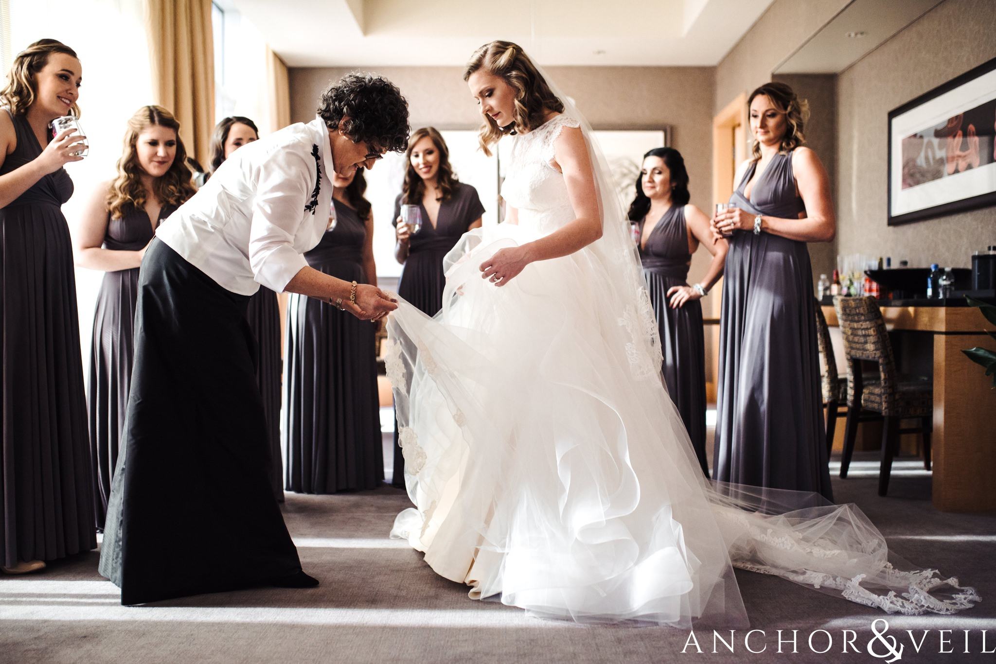 getting the dress on during their ritz Carlton wedding in Uptown Charlotte NC