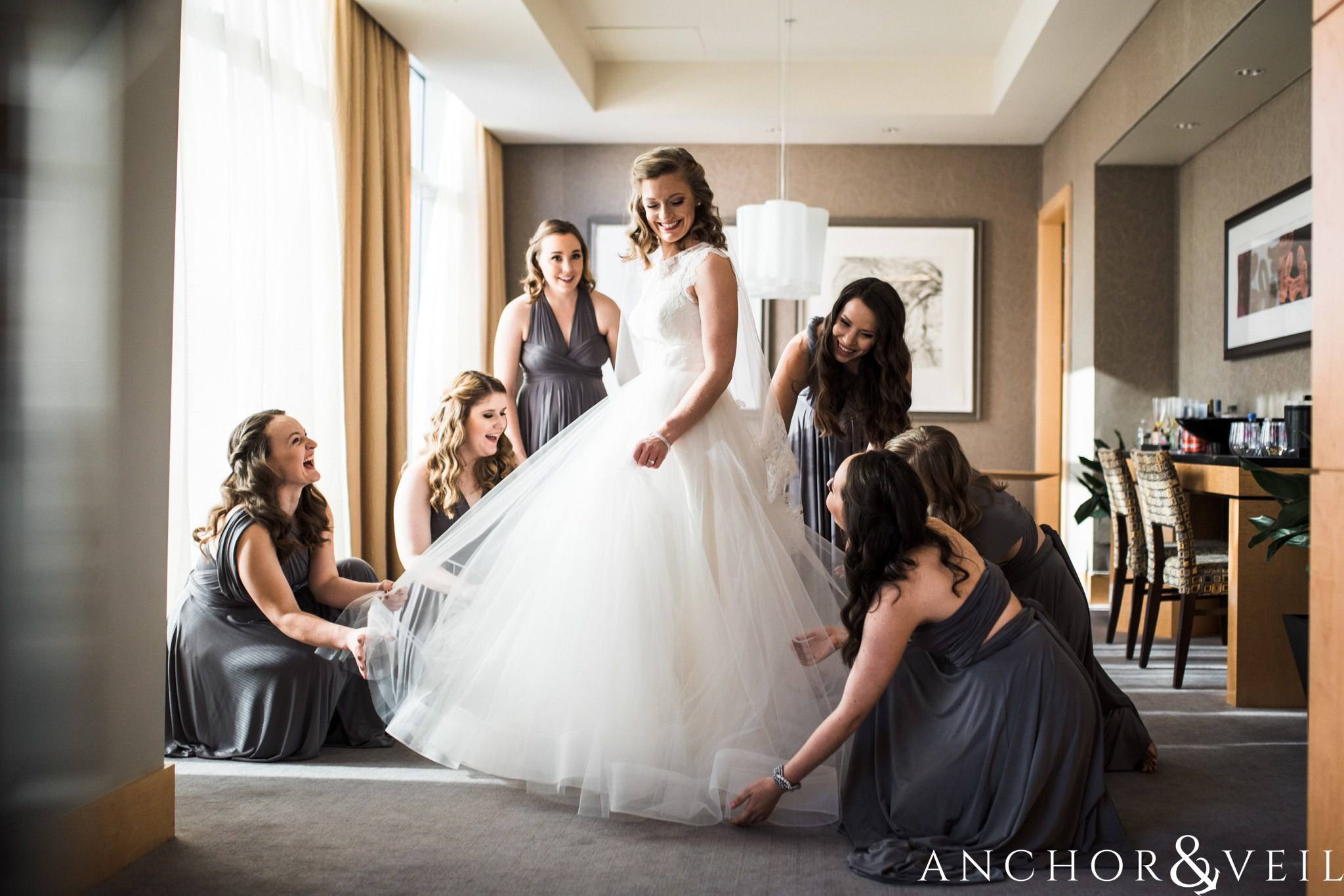 fluffing the dress during their ritz Carlton wedding in Uptown Charlotte NC