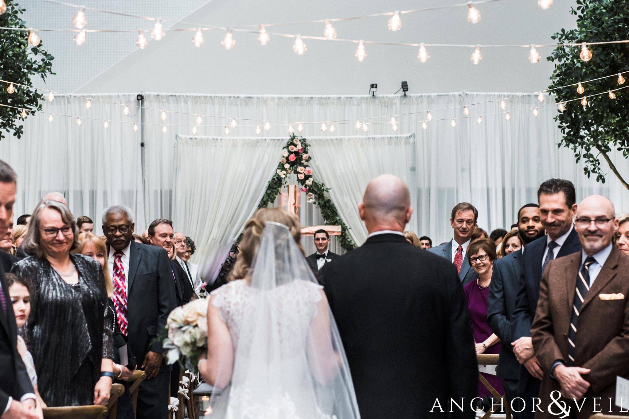 walking down the aisle in the ceremony during their ritz Carlton wedding in Uptown Charlotte NC