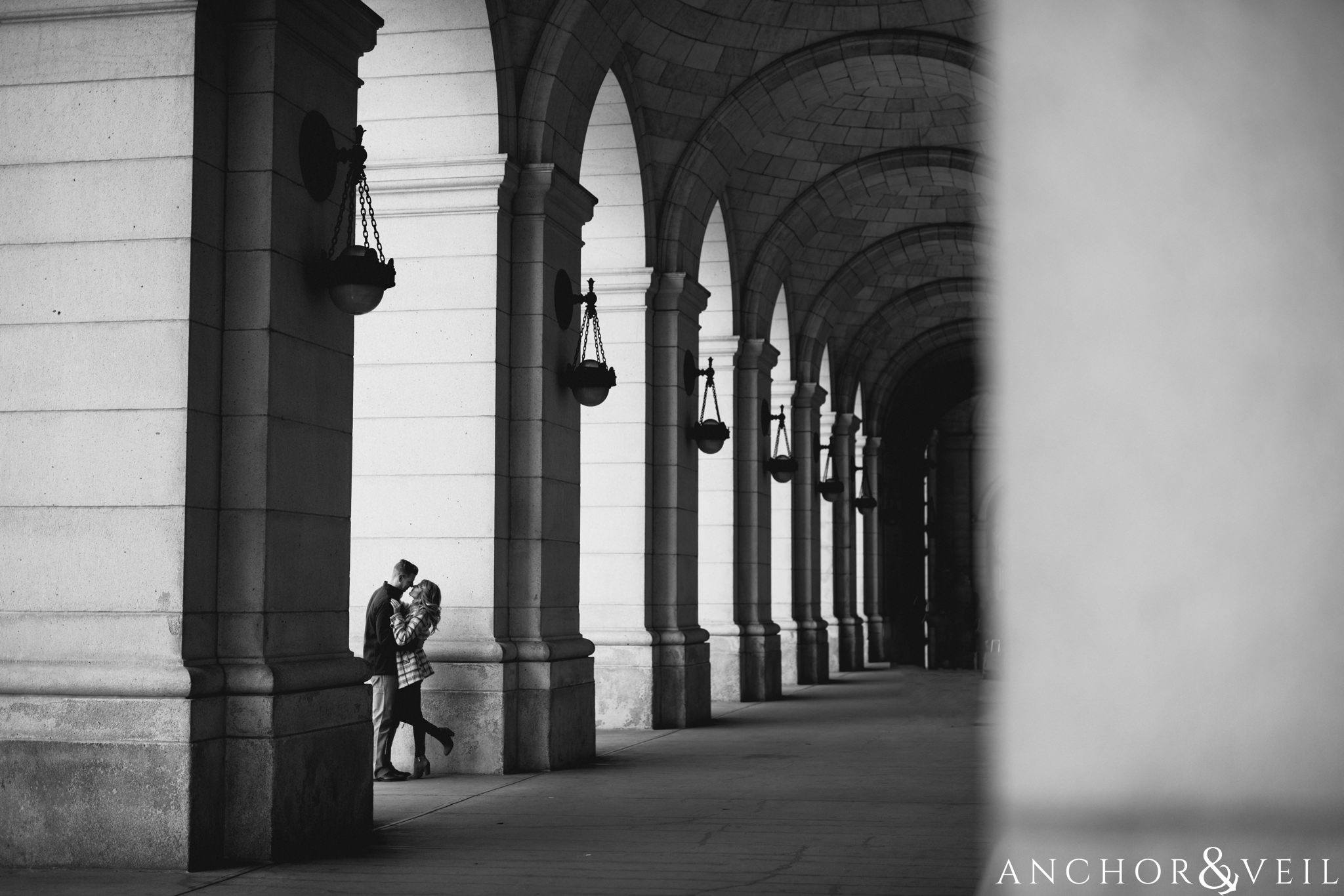 arches and architect at union station during their Scenic Washington DC Engagement Session