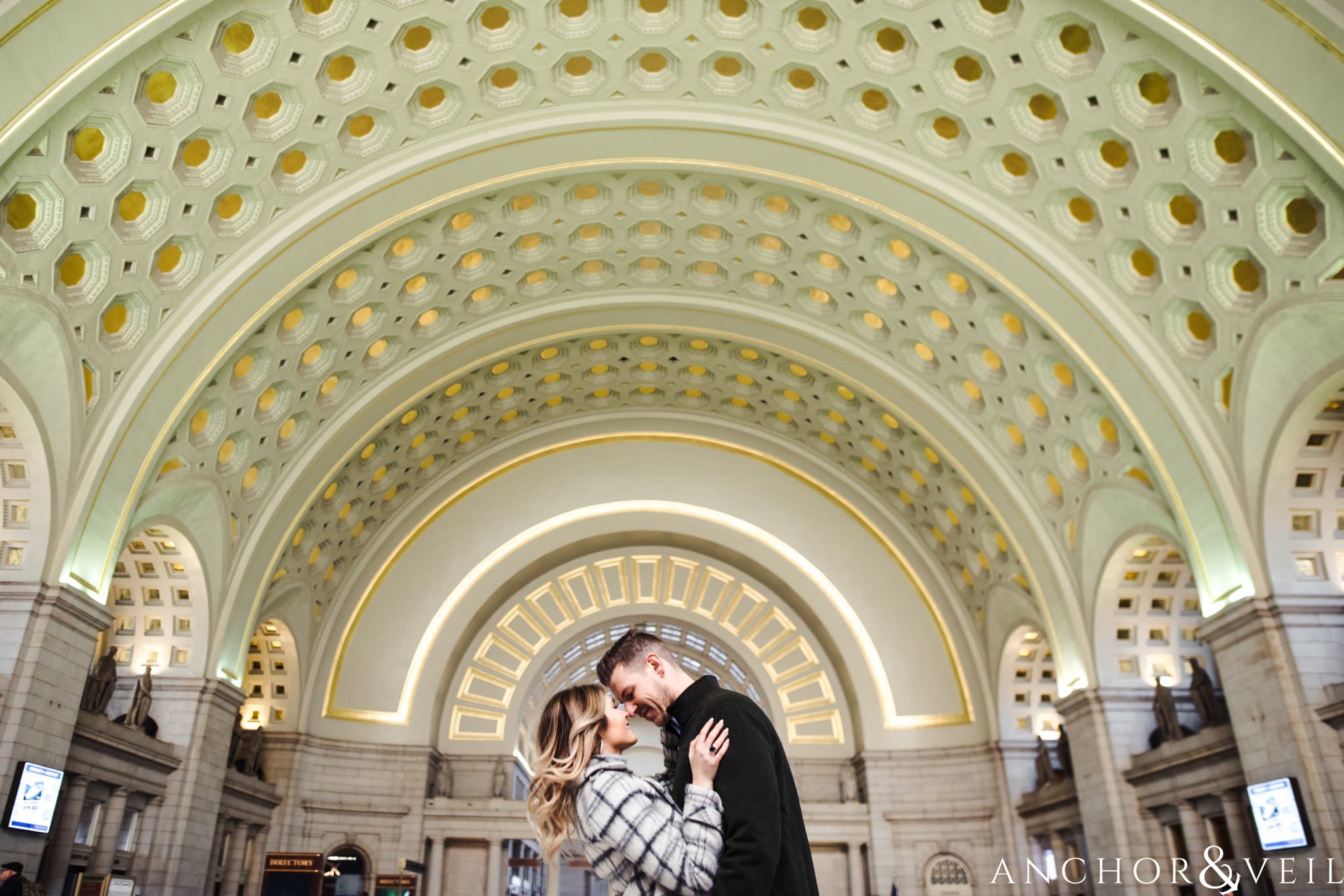 the golden ceiling at union station during their Scenic Washington DC Engagement Session