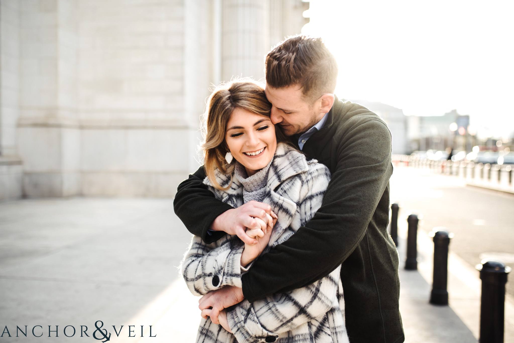 hugging next to the pillars during their Scenic Washington DC Engagement Session