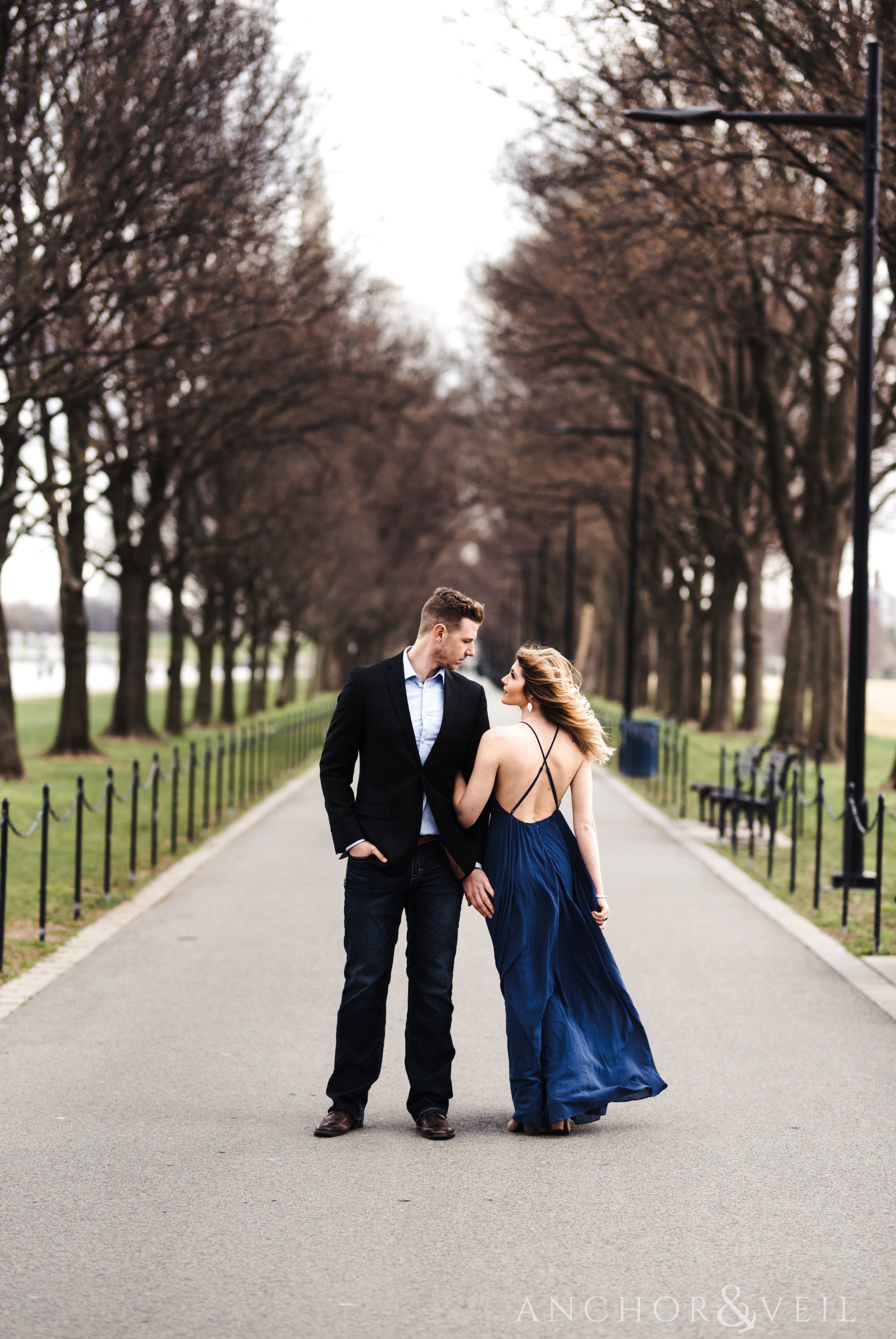 along the walkway of trees during their Scenic Washington DC Engagement Session
