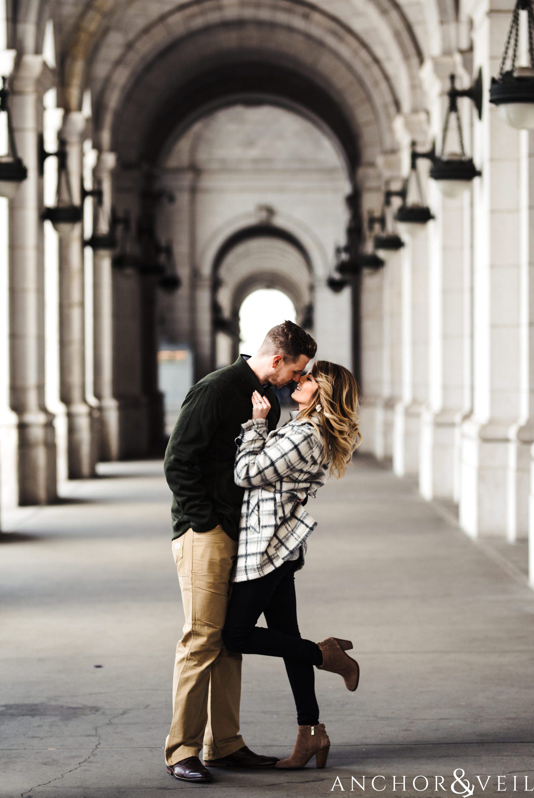 under the arches at union station during their Scenic Washington DC Engagement Session