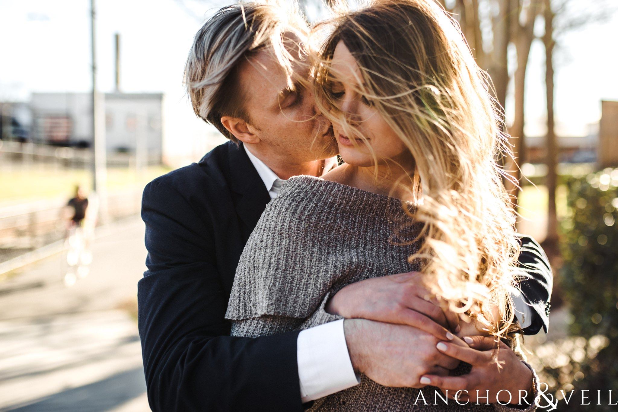 wind blown hair during their shorthand Charlotte engagement session