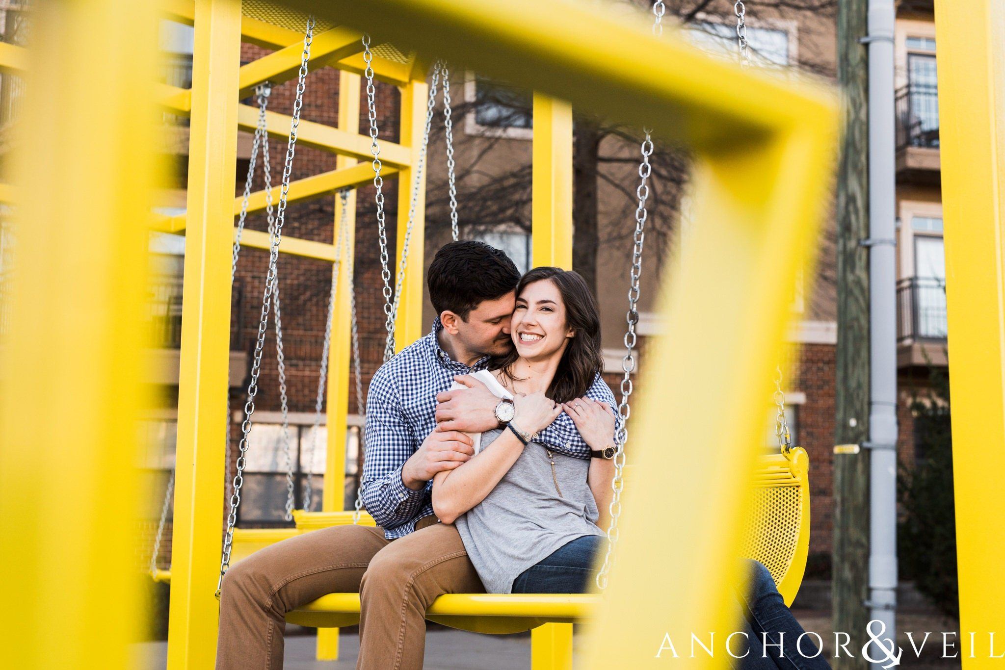 yellow benches during their southend Charlotte and Jetton park engagement session