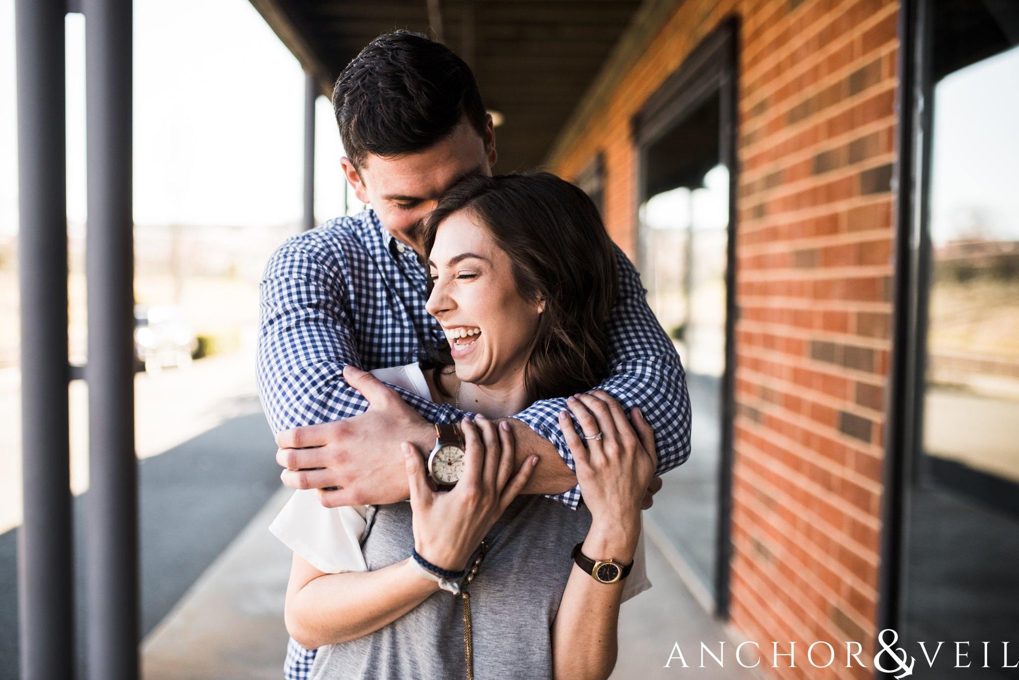 holding her tight during their southend Charlotte and Jetton park engagement session