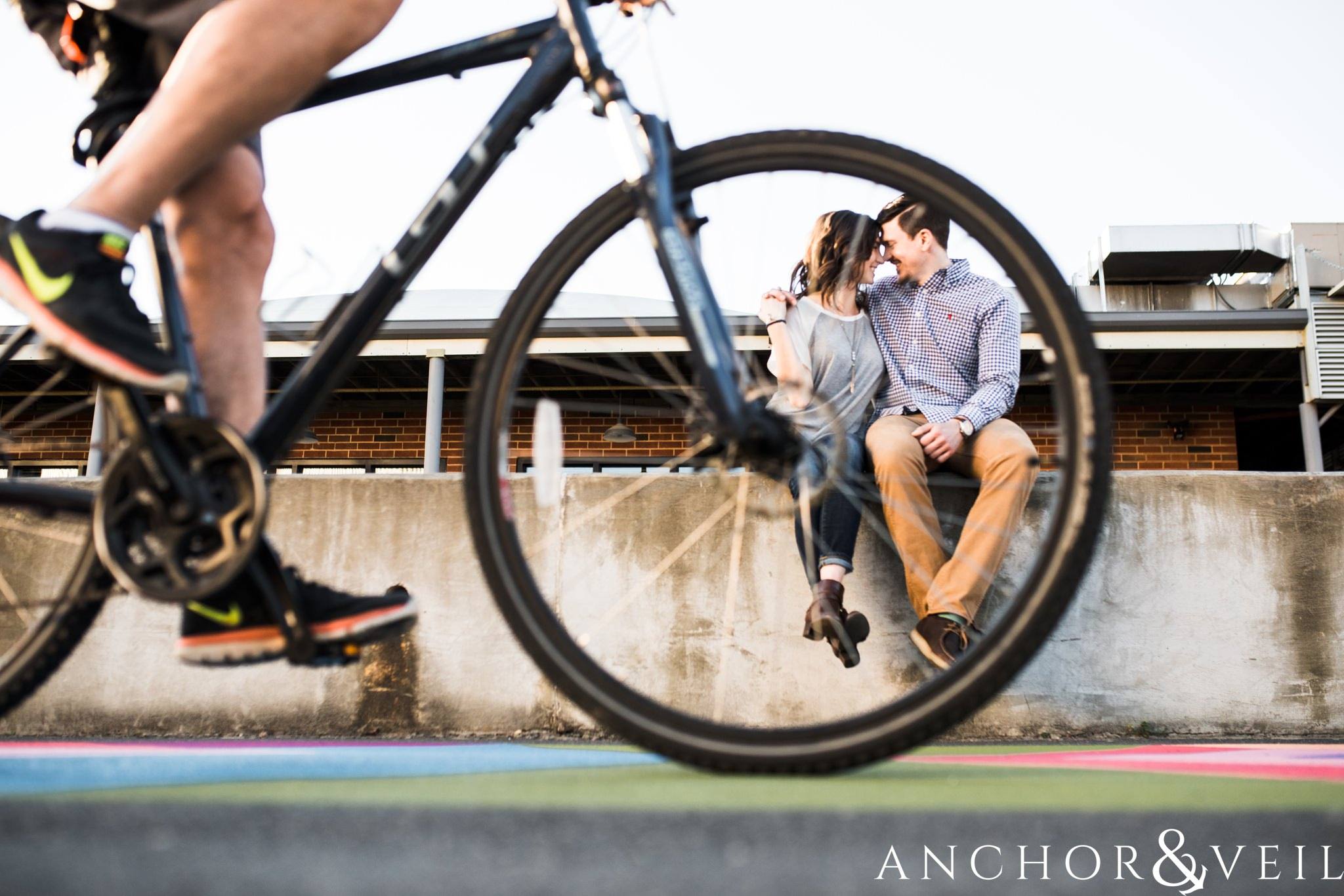 under the bike wheels during their southend Charlotte and Jetton park engagement session