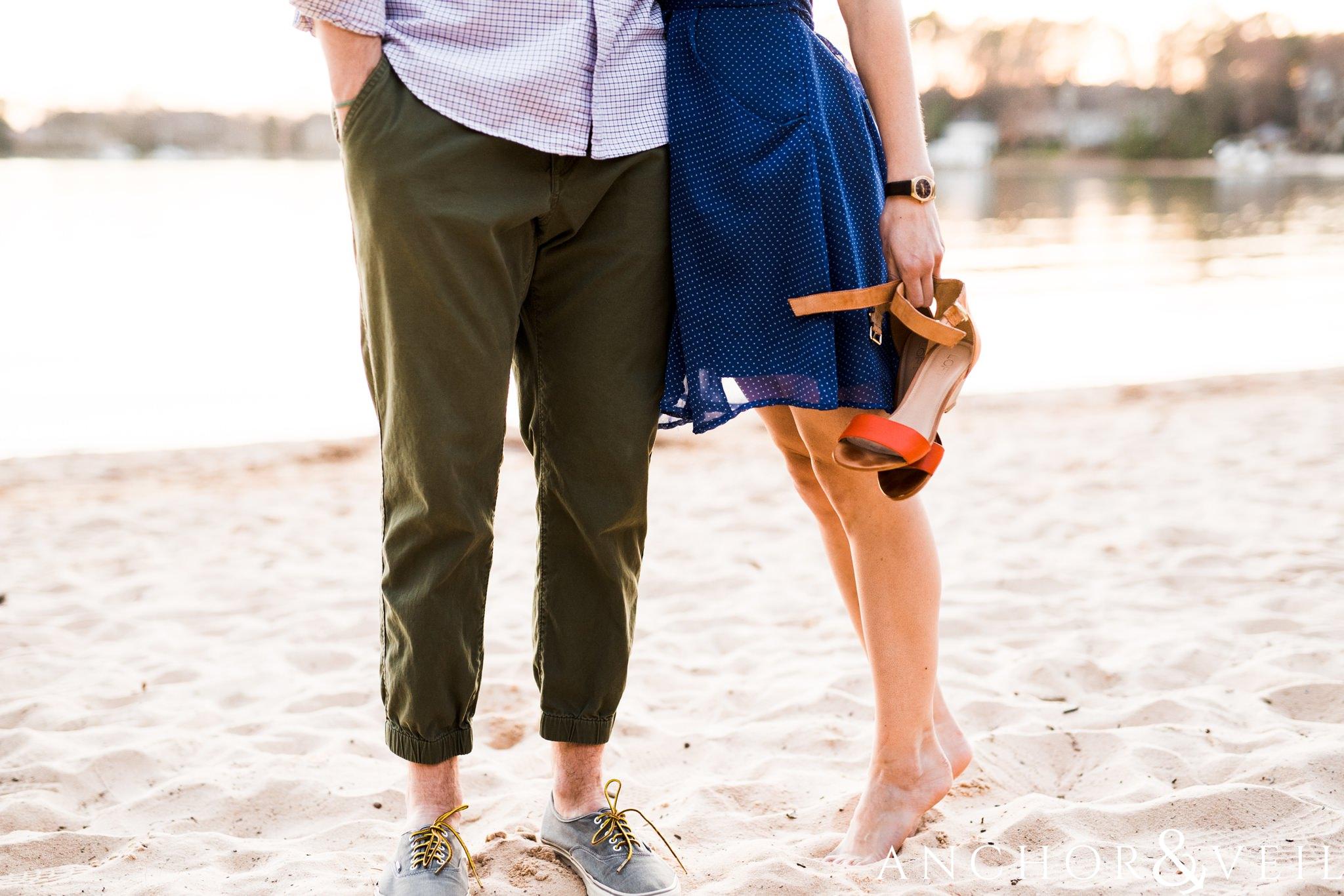 shoes ont eh beach during their southend Charlotte and Jetton park engagement session