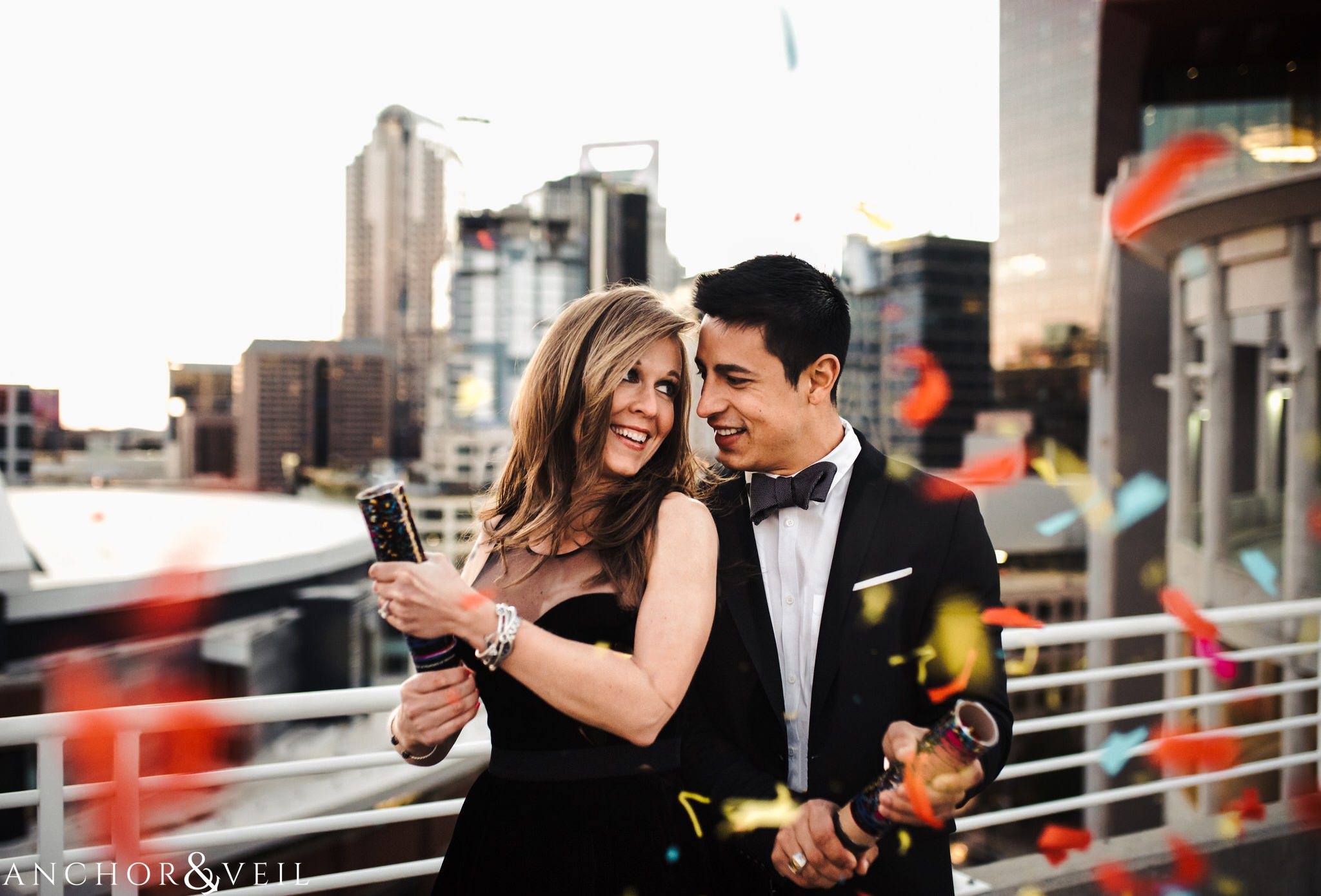 confetti and parking decks During their Uptown Charlotte Engagement Session