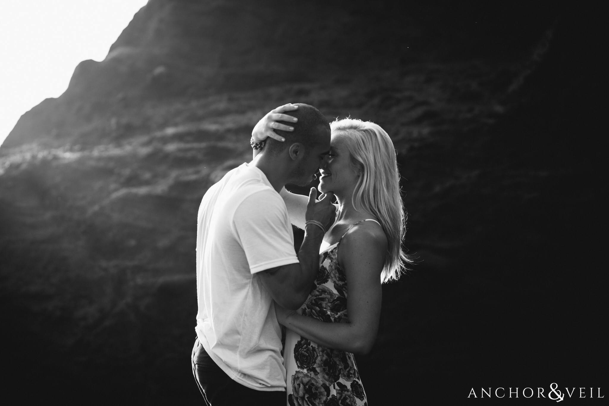 kissing her close during their Eternity Beach Session in Honolulu Hawaii Halona Cove