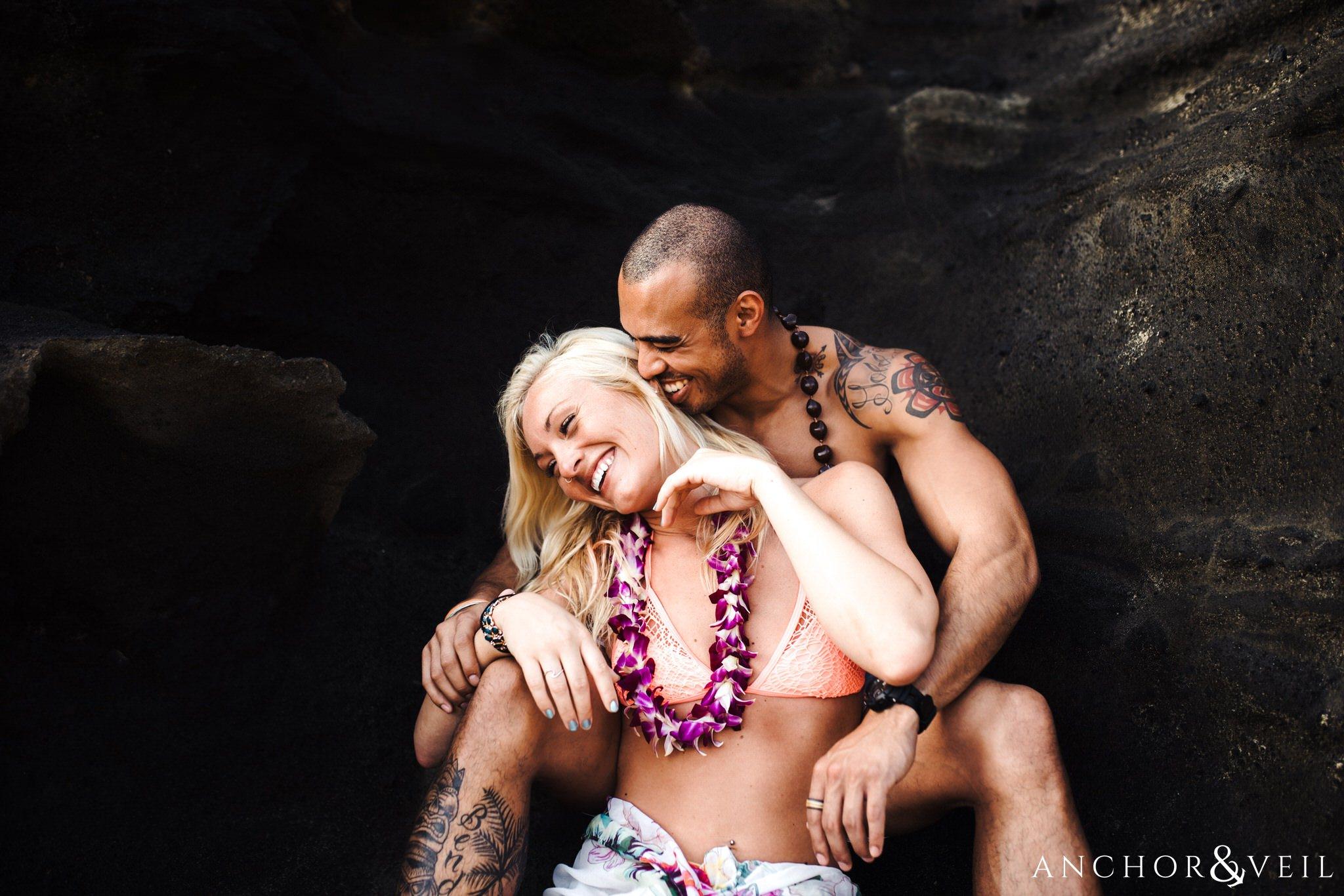 laughing toward each other during their Eternity Beach Session in Honolulu Hawaii Halona Cove