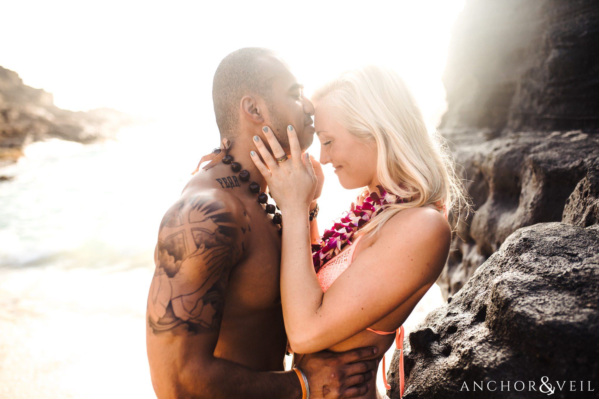 kissing softly during their Eternity Beach Session in Honolulu Hawaii Halona Cove