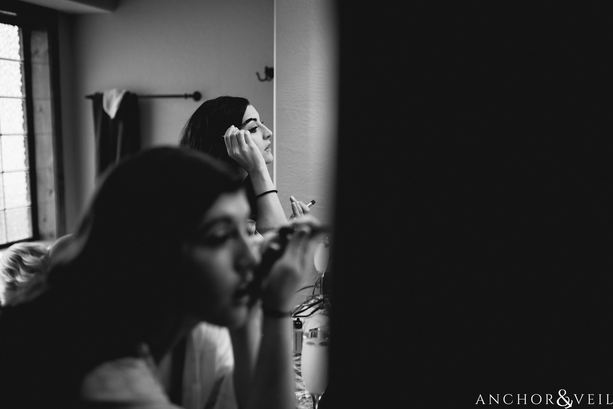 bride and sister putting makeup on during their Horseshoe Bend Elopement Wedding