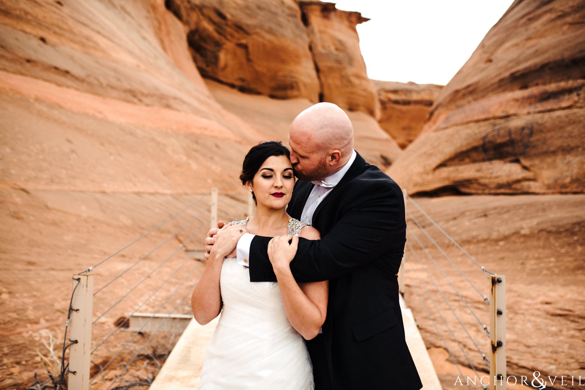 kissing her head during their Horseshoe Bend Elopement Wedding