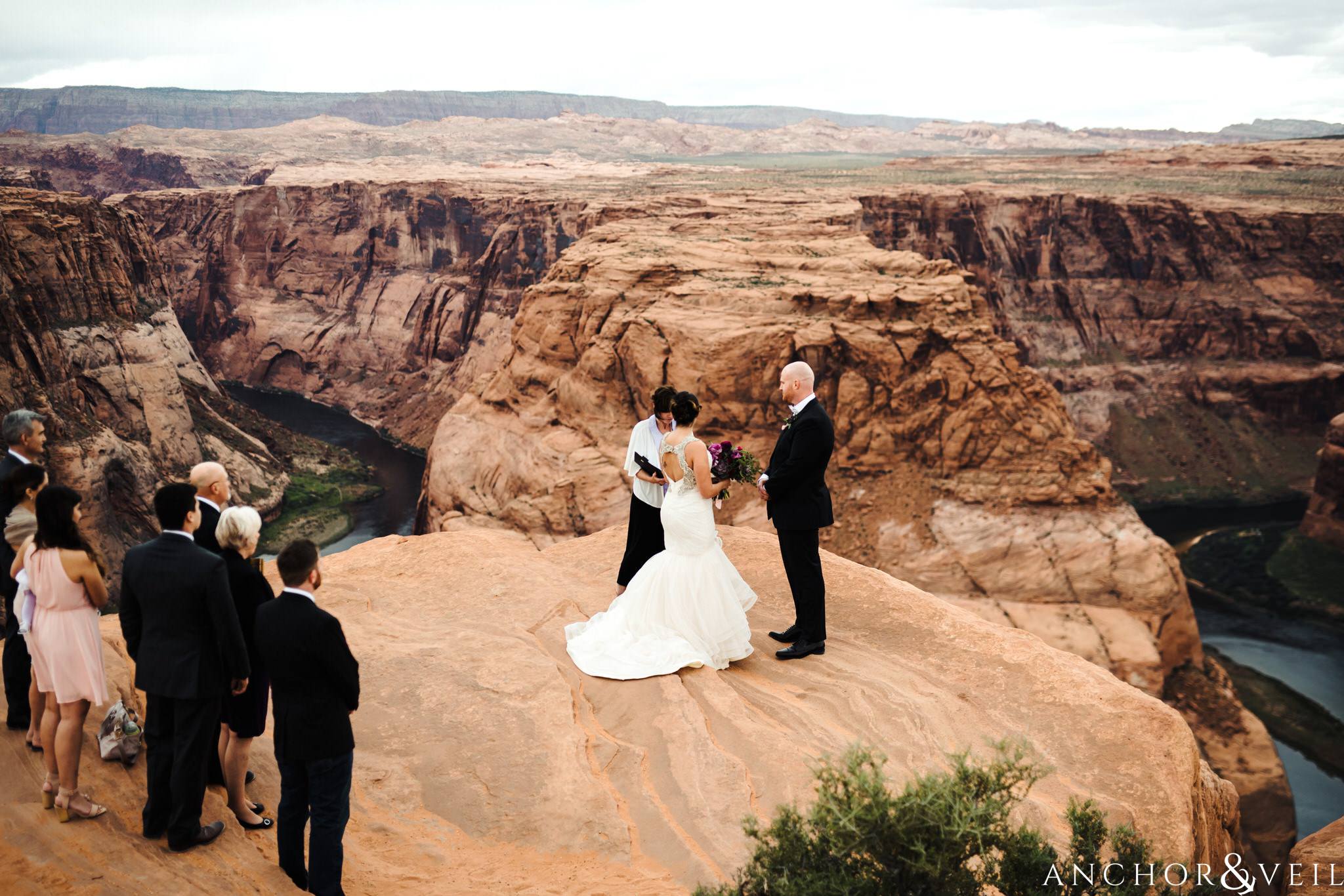 standing during the ceremony during their Horseshoe Bend Elopement Wedding
