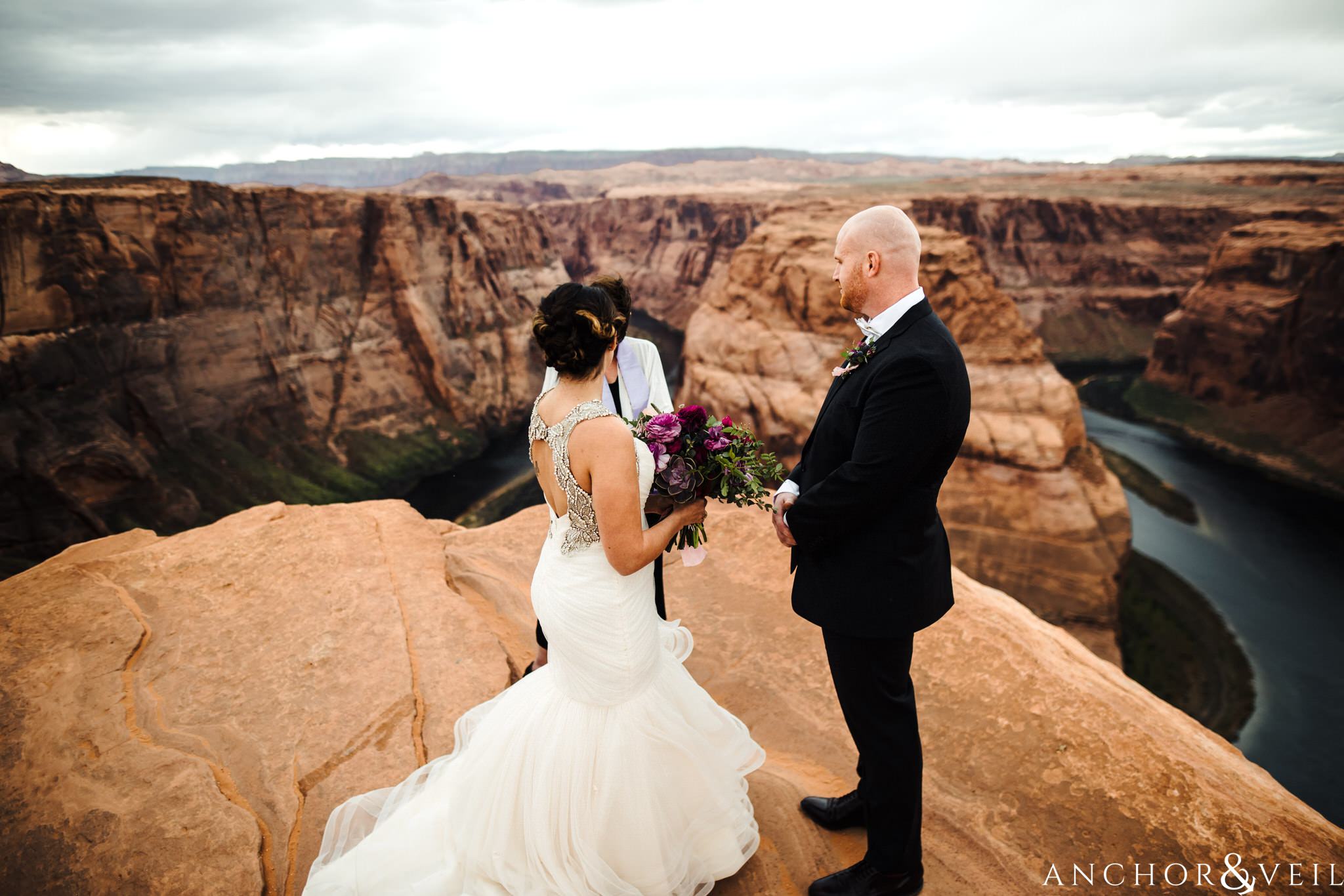 standing at the edge during their Horseshoe Bend Elopement Wedding