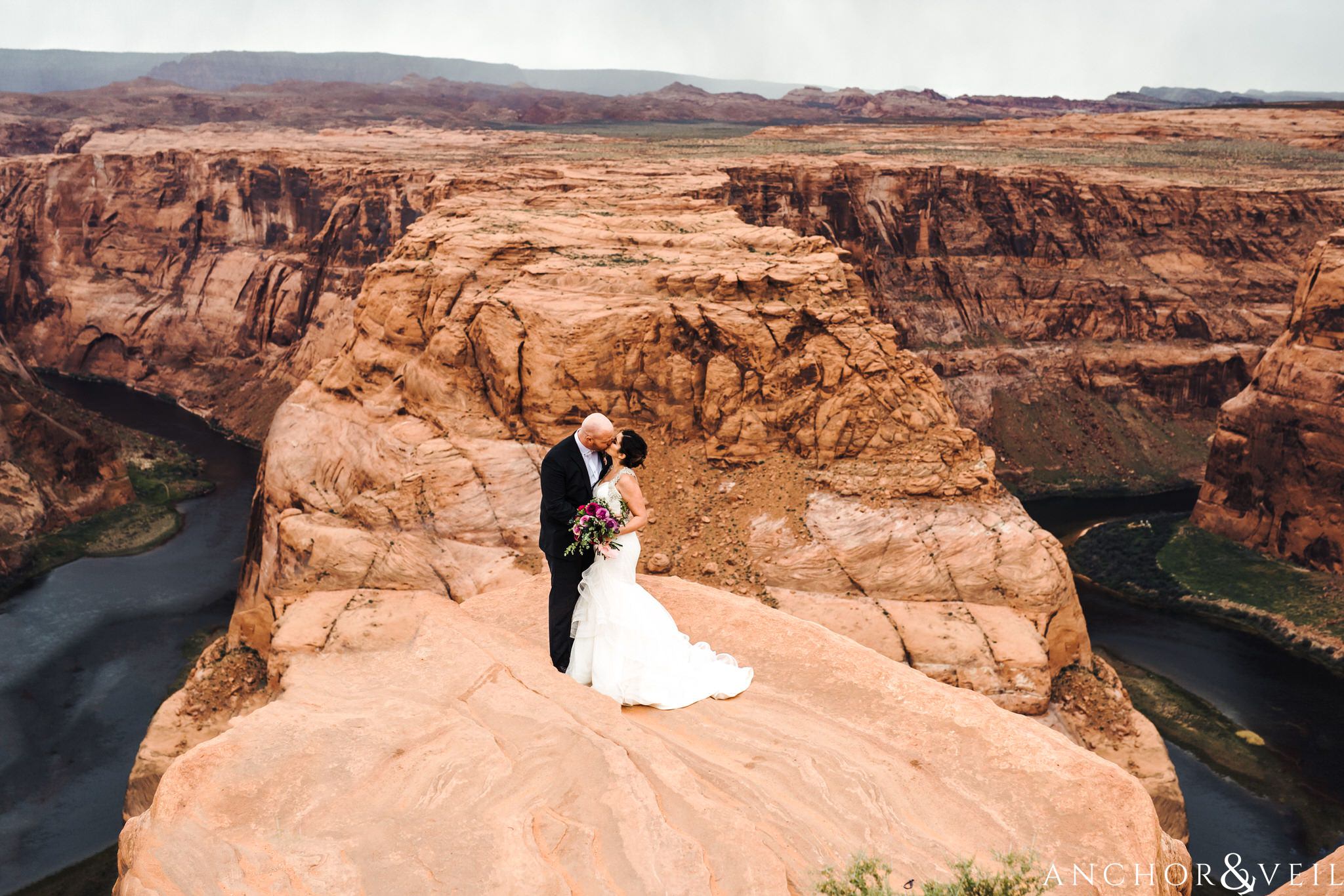 kissing on the edge during their Horseshoe Bend Elopement Wedding