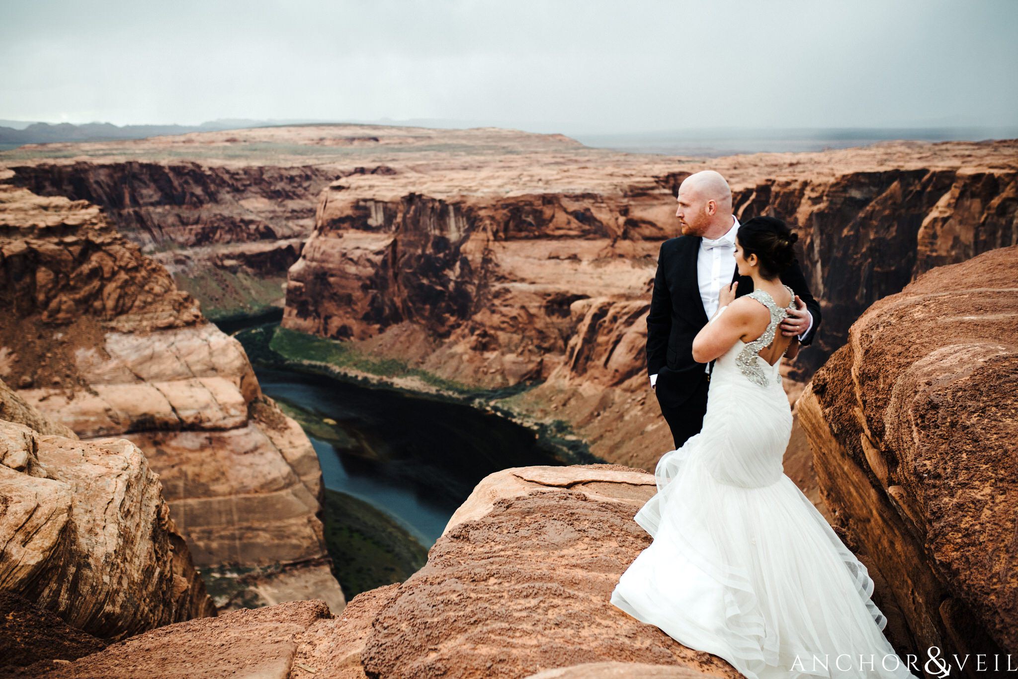 on the edge looking out during their Horseshoe Bend Elopement Wedding