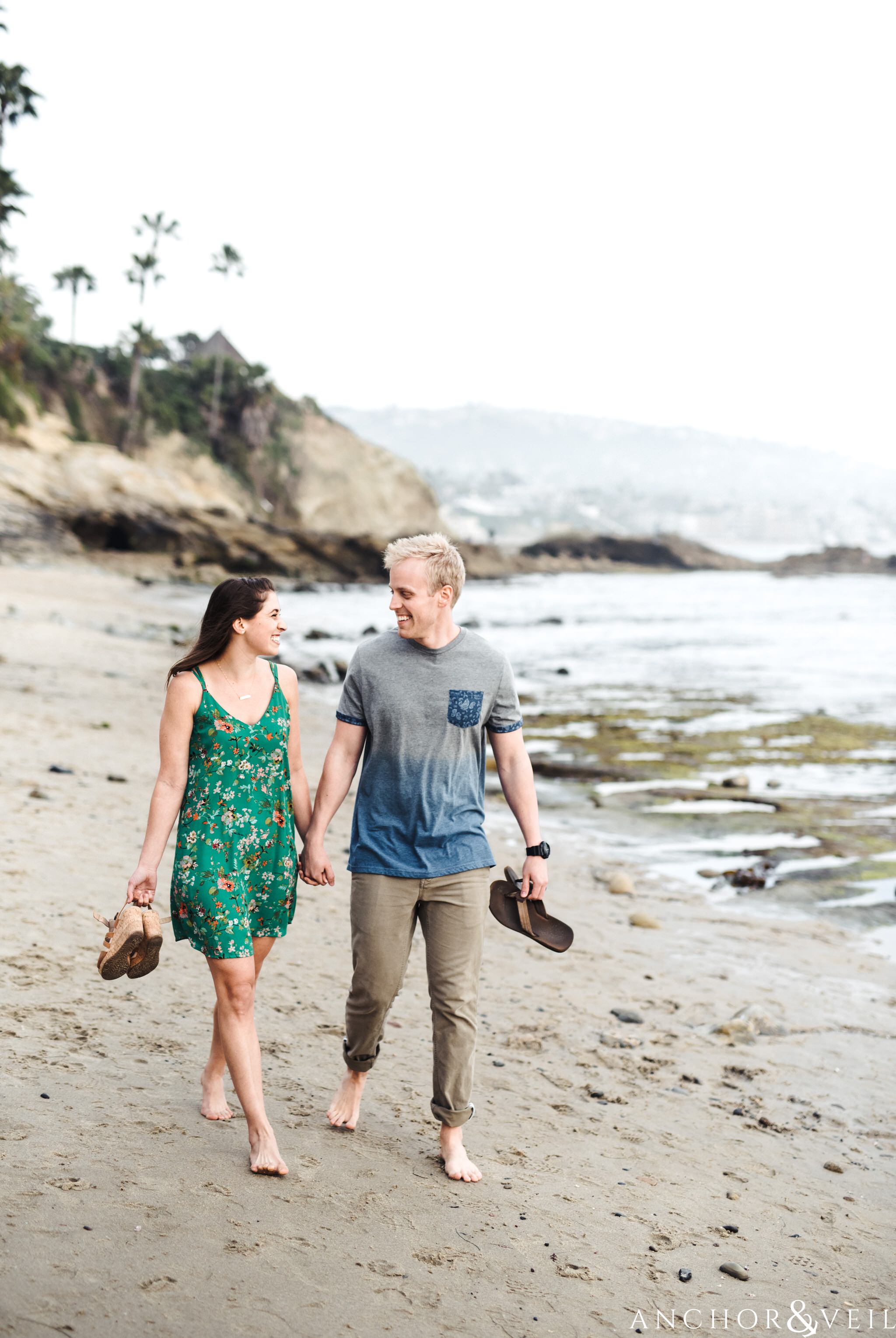 walking on the beach during their Laguna Beach Engagement Session 35